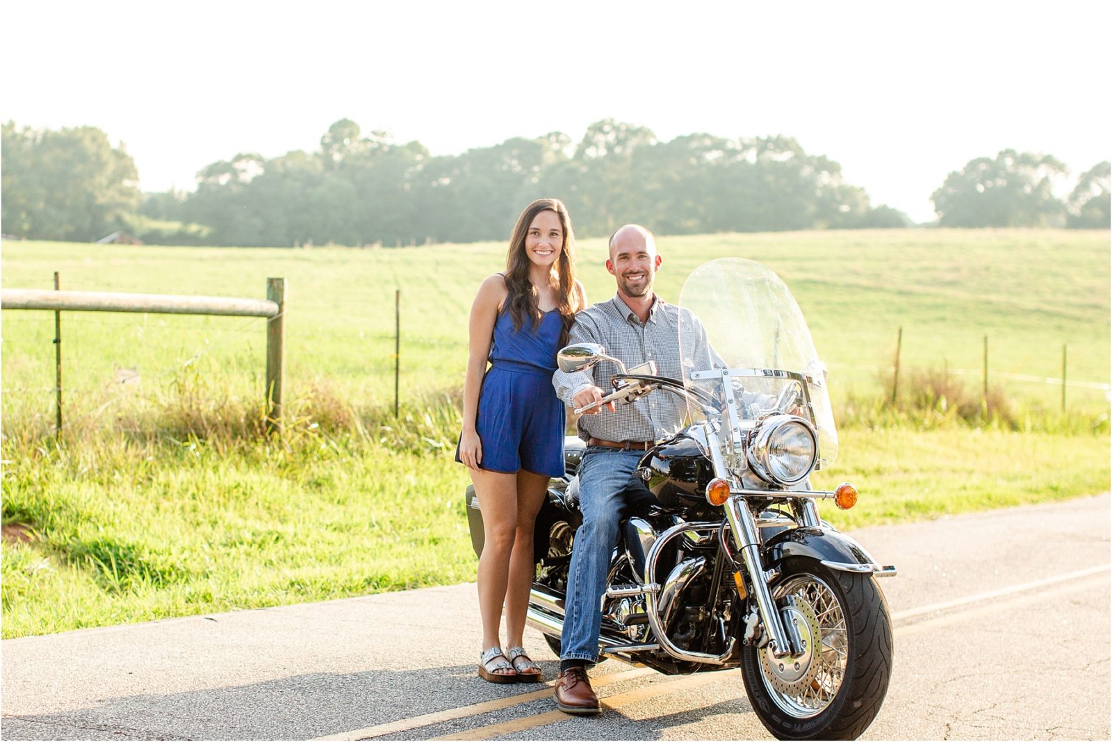 Engaged woman standing next to man on motorcycle