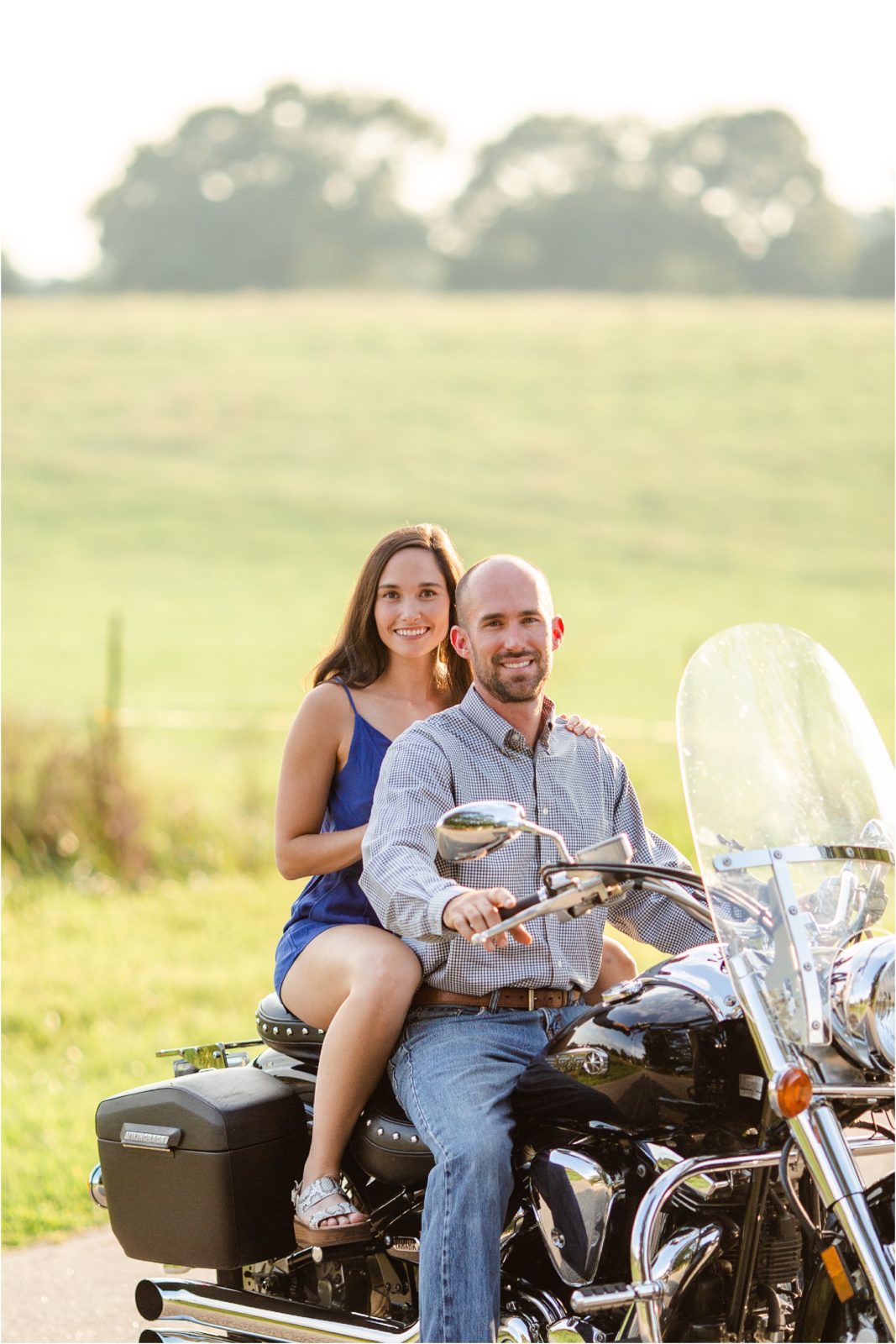 Couple taking engagement pictures on motorcycle