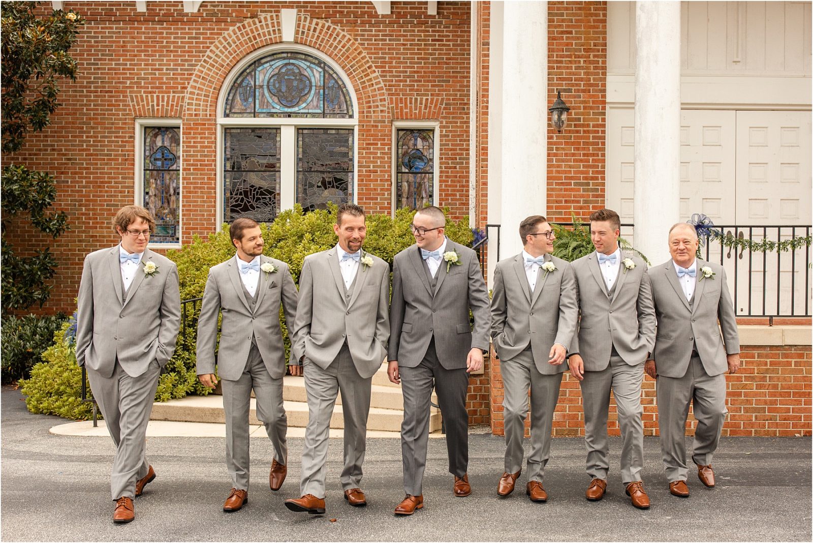 Men in grey suit walk in front of church