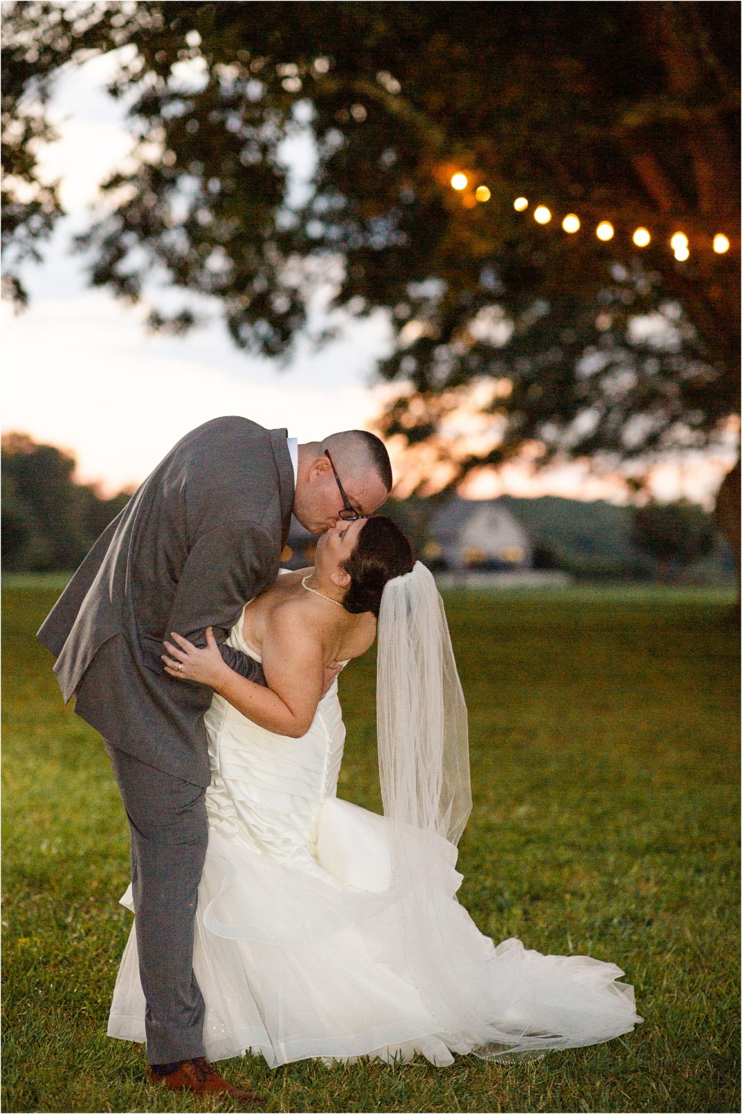 Man dips bride in wedding gown