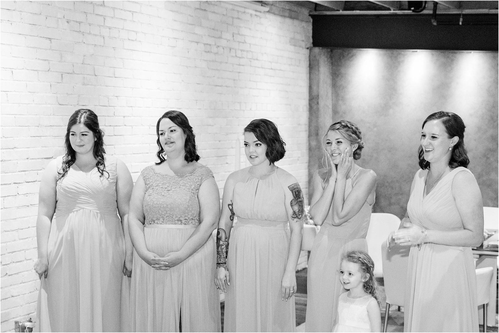 Bridesmaids smile during first look