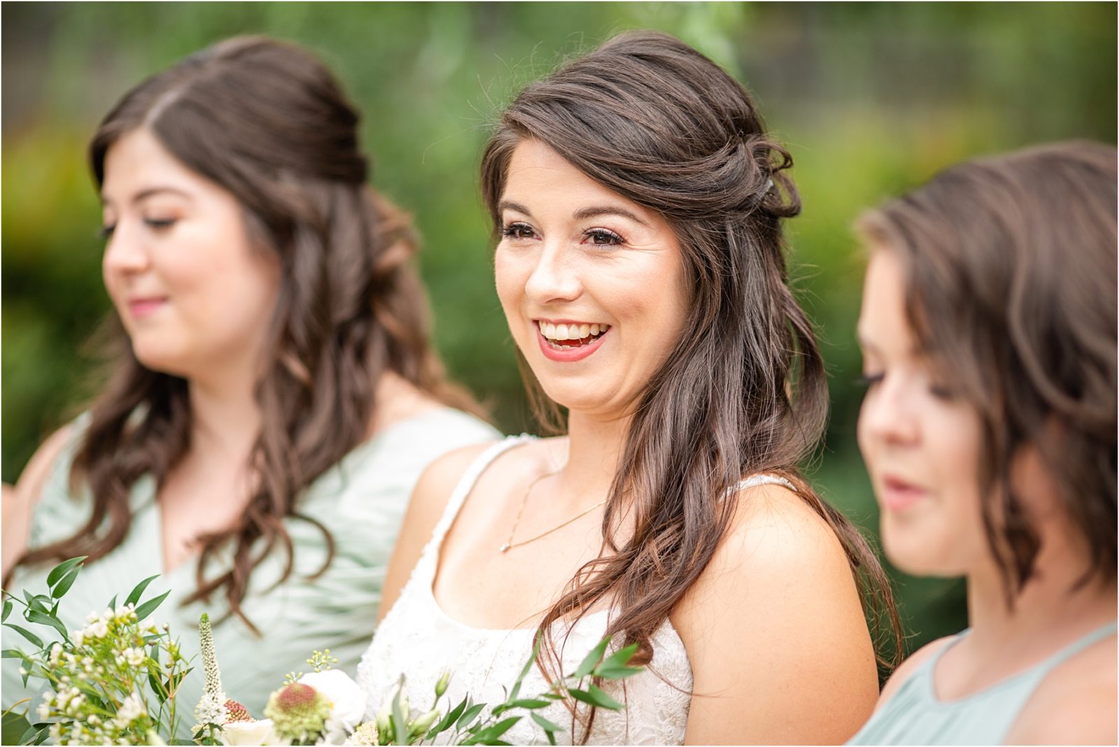 Bride in wedding gown smiles at friends