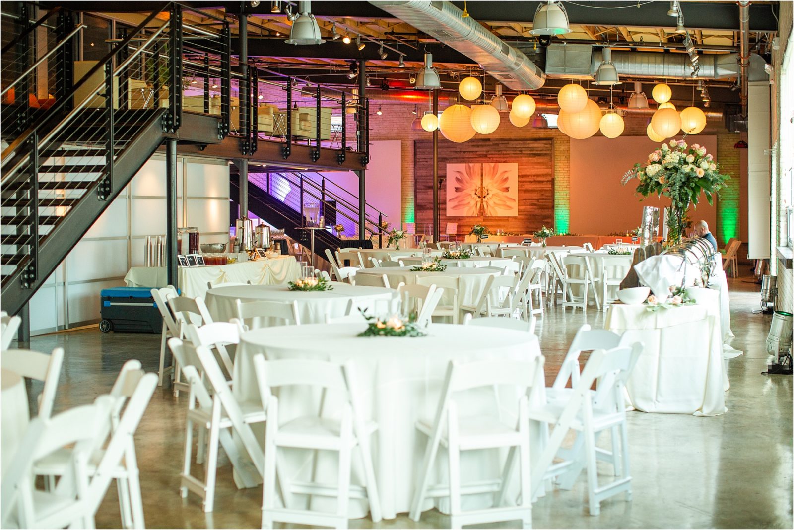 White tables with white chairs in Zen event space