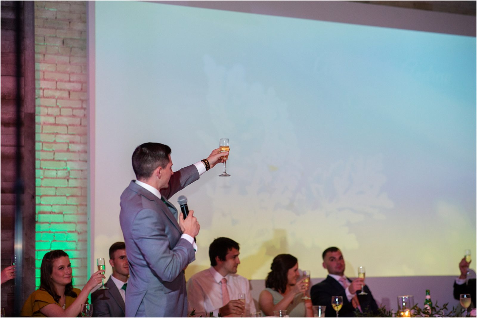 Best man raises glass during speech