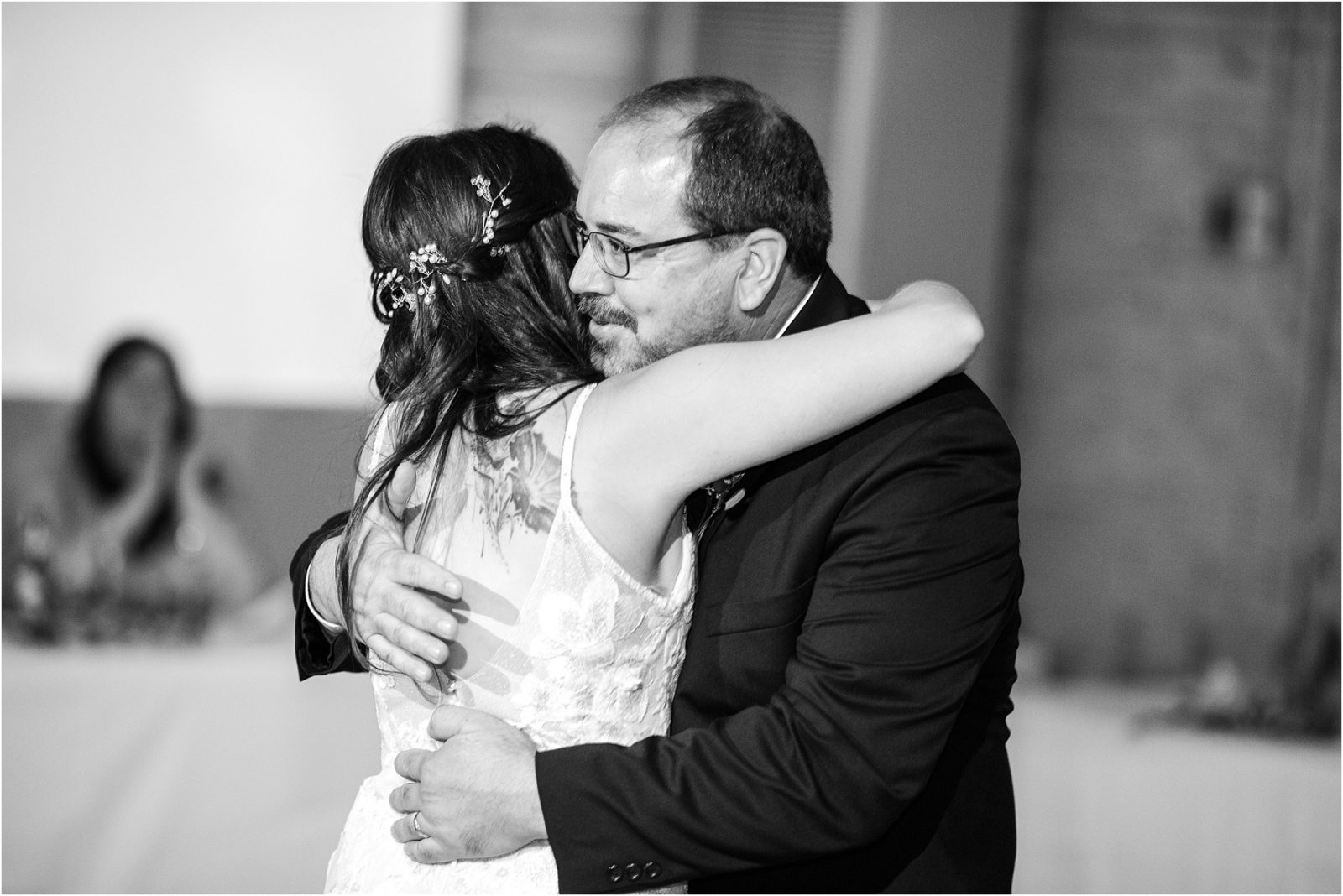 Bride in wedding dress dances with her father