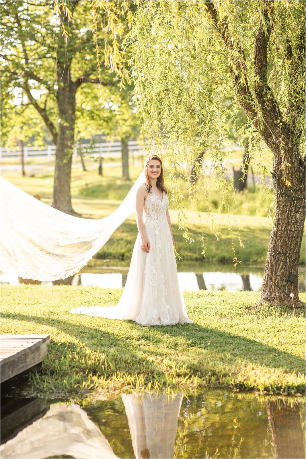 Bride standing next to pond