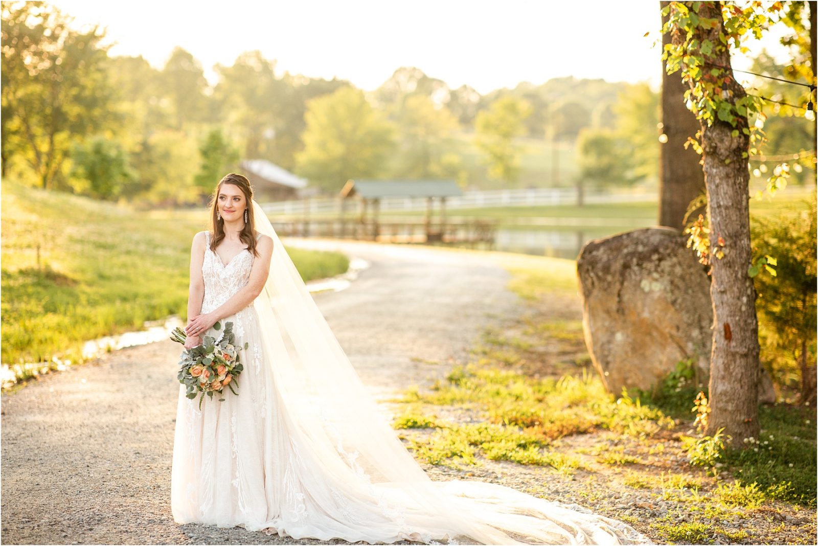 Woman in wedding dress standing on pathway on farm