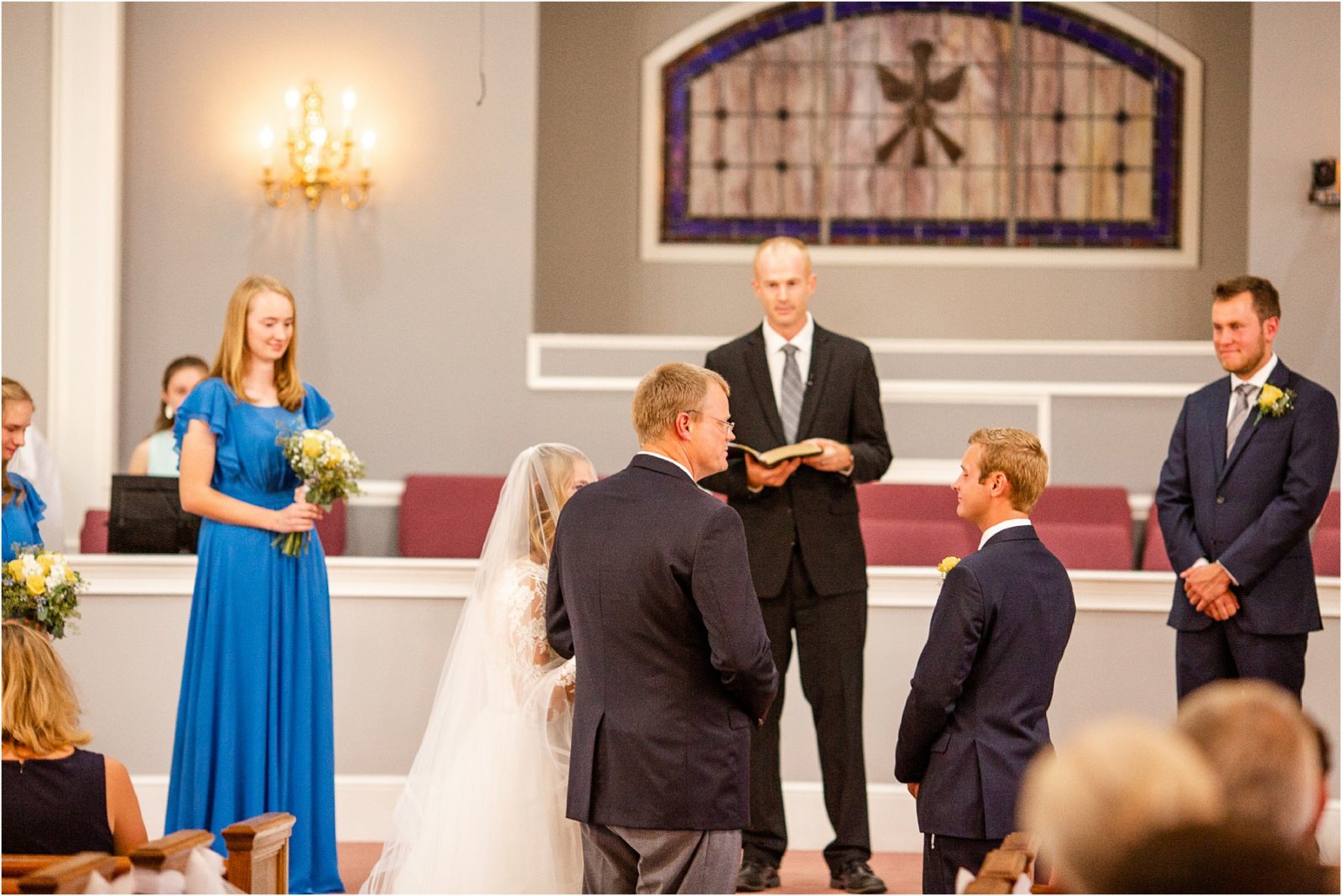 Father of bride giving away daughter to groom