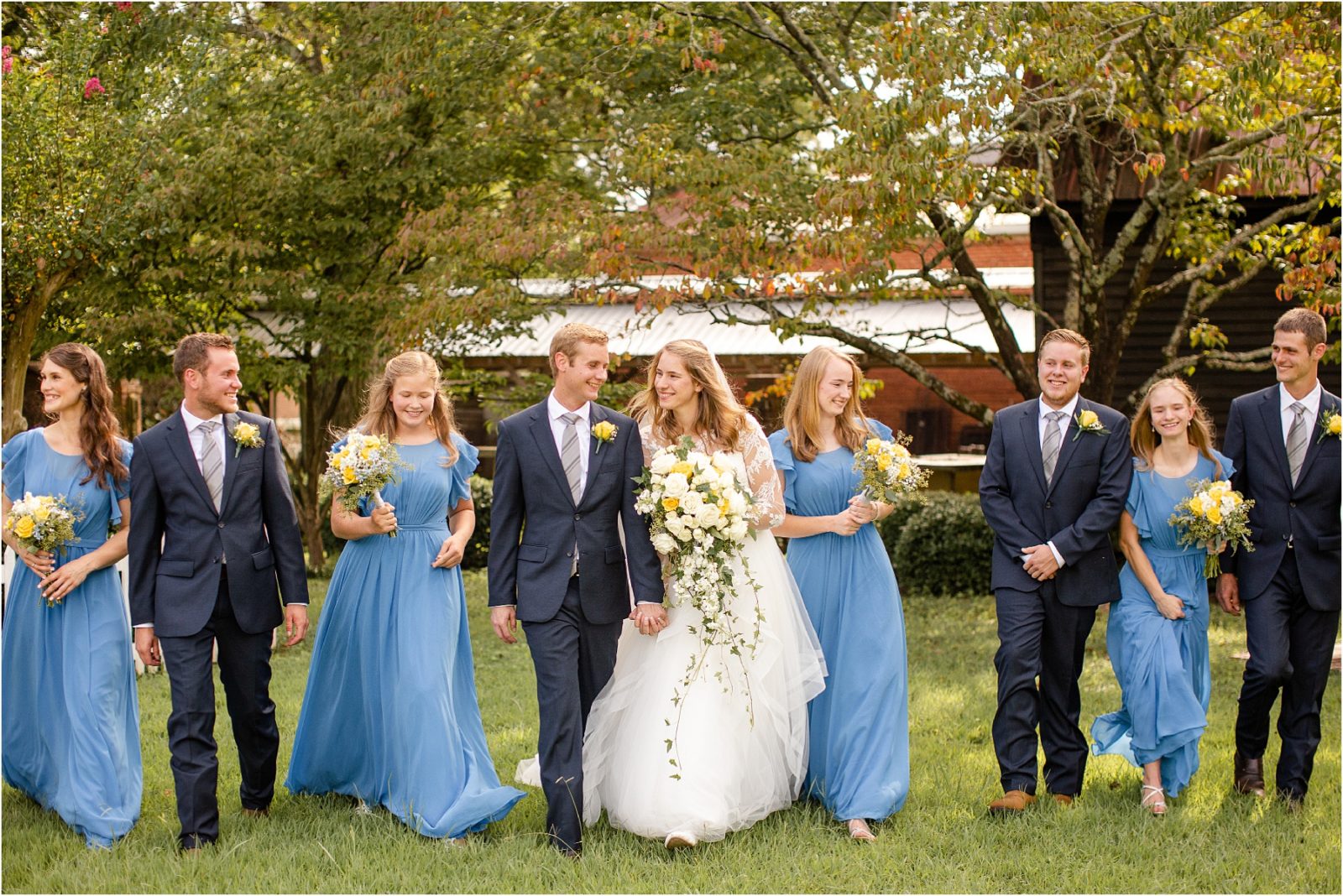 Bridal party walks with bride and groom