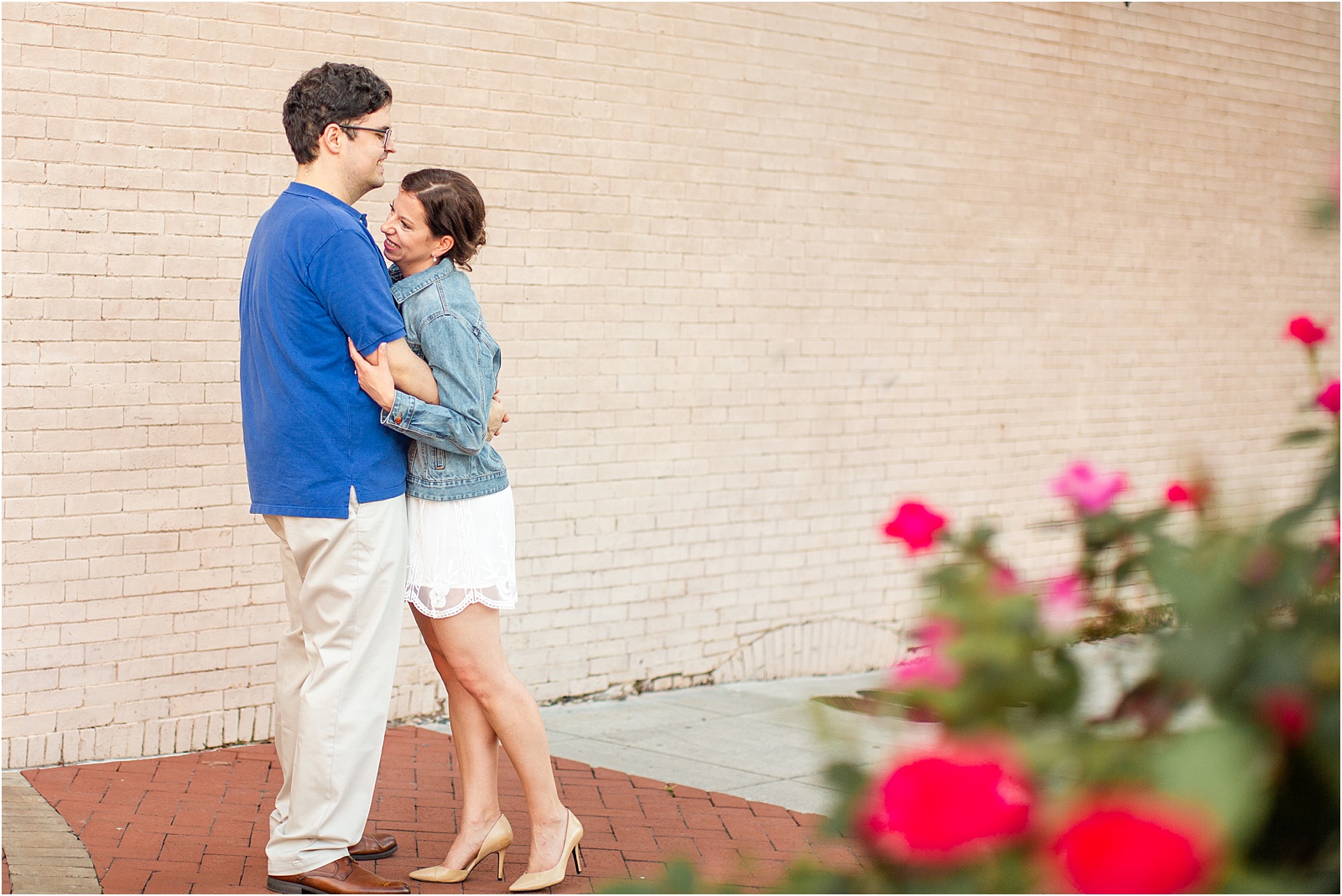 Laughing couple taking engagement pictures in downtown