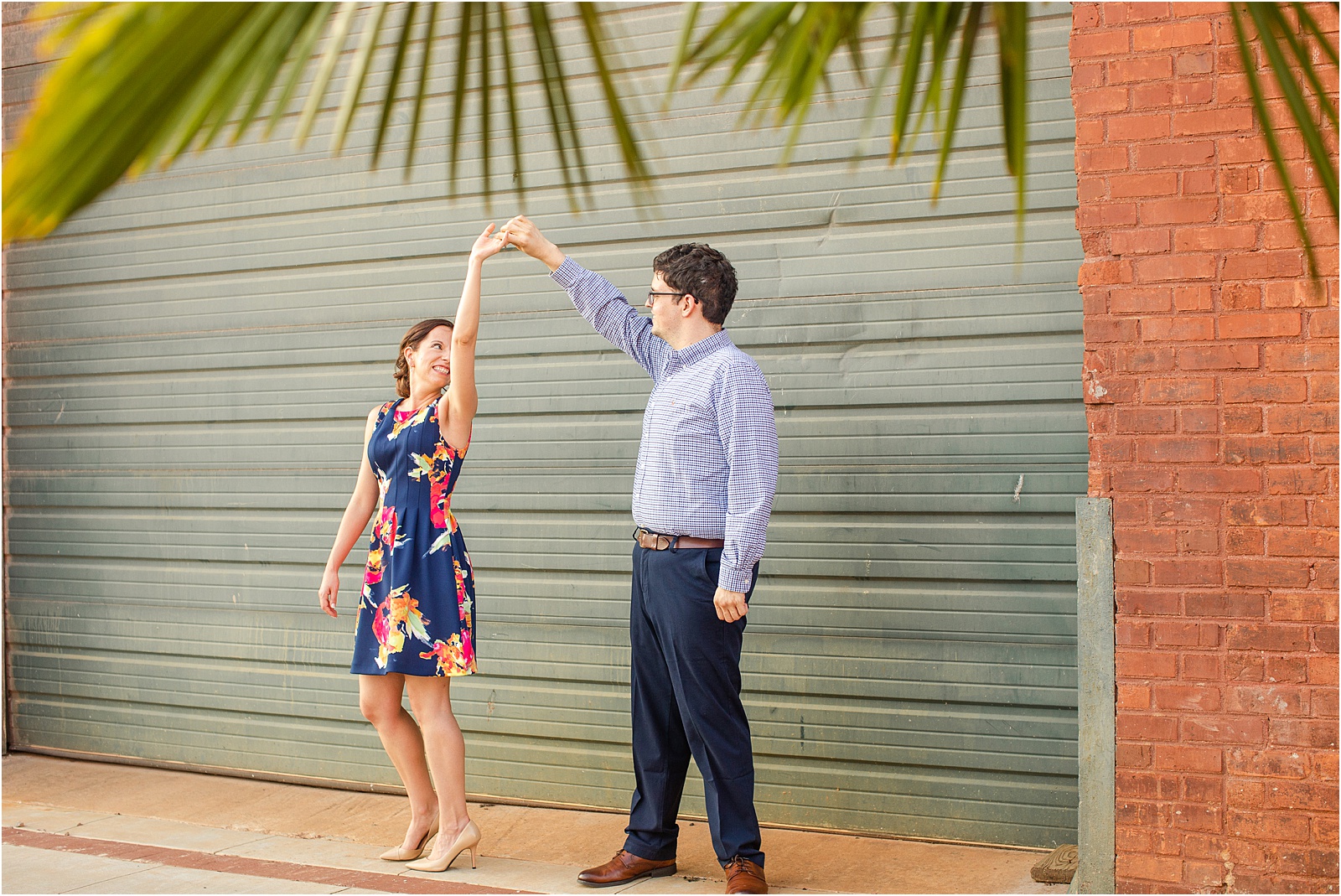 Guy twirling woman during engagement session