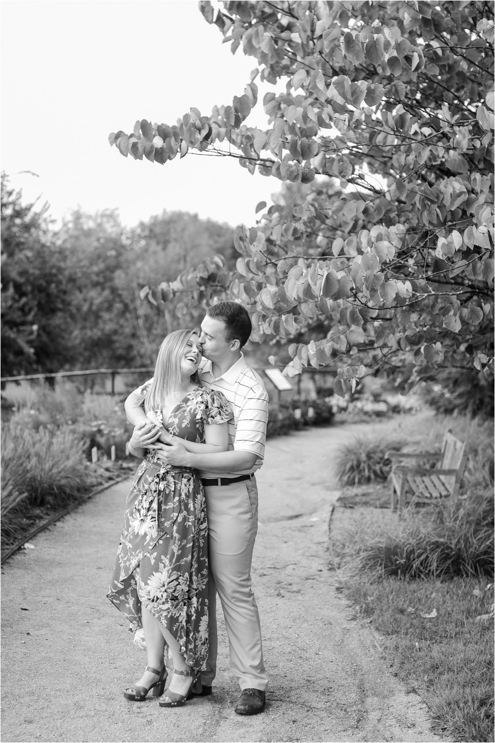 couple hugging on pathway in Kentucky botanical garden