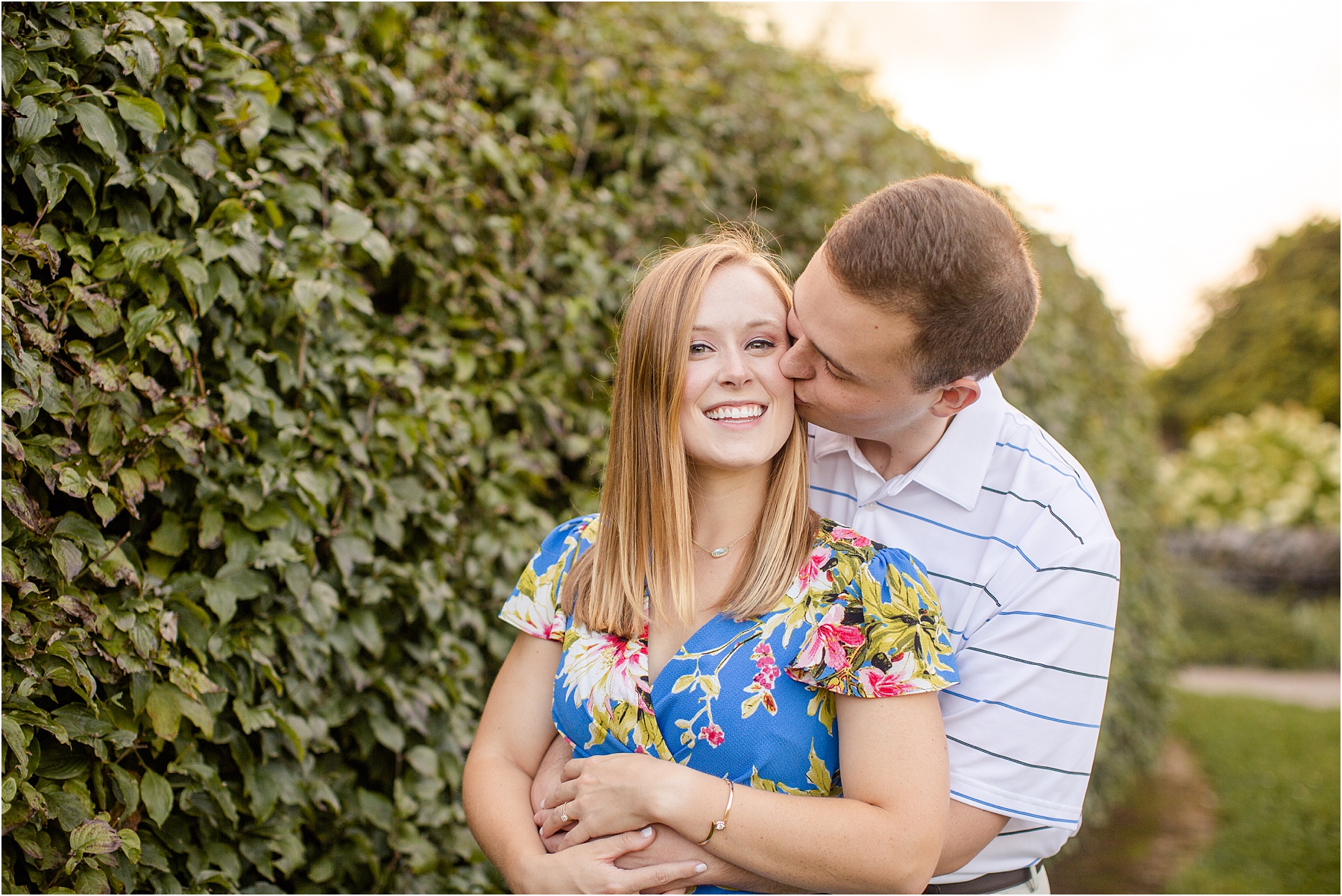 Guy kissing girls cheek in Kentucky for engagement photos