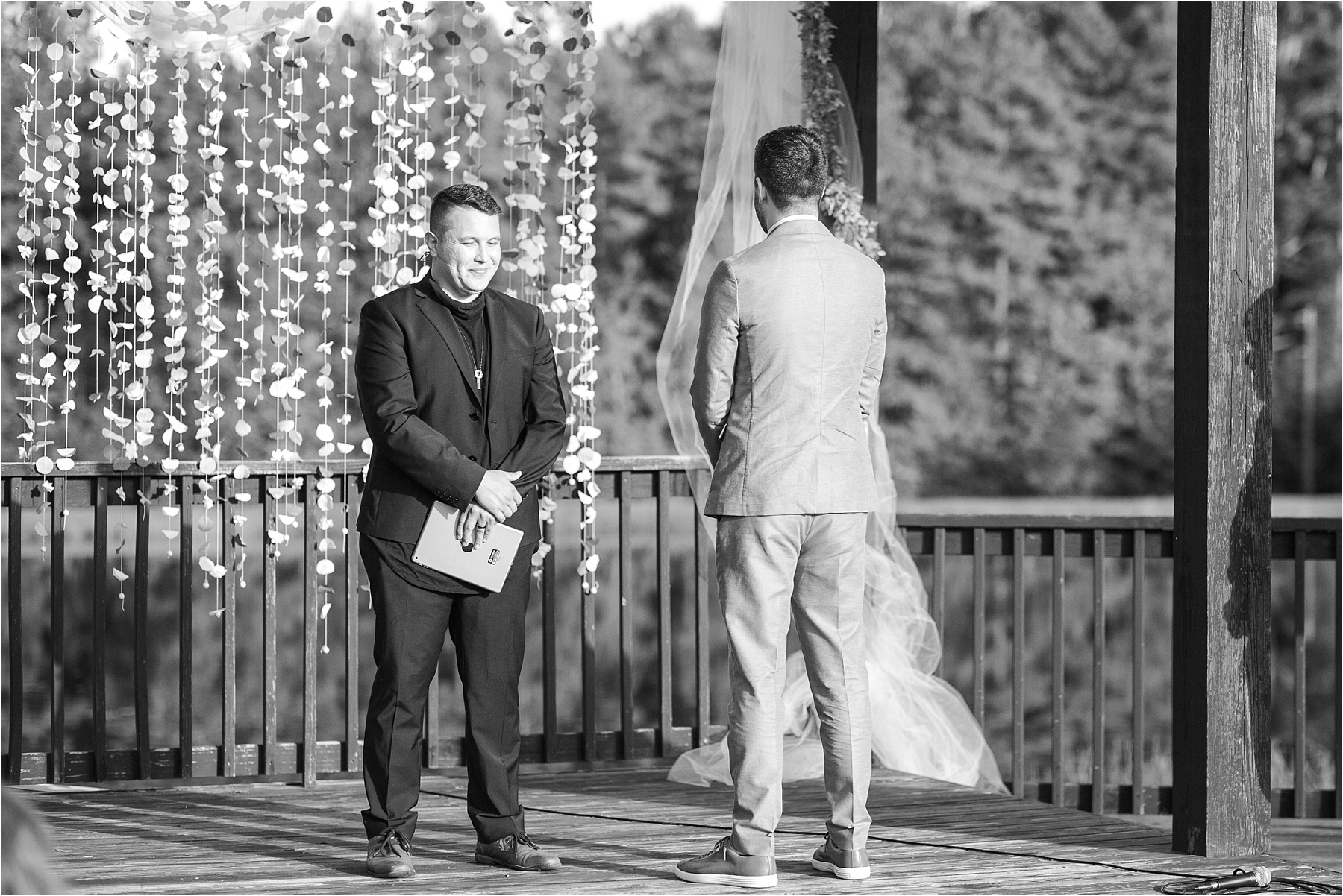 Groom stares away as bride walks down wedding aisle