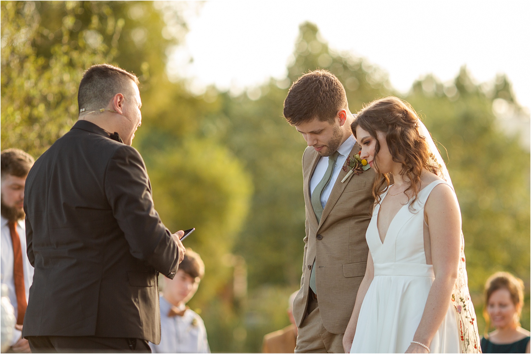 Pastor prays with bride and groom during the wedding in Greenville SC vineyard