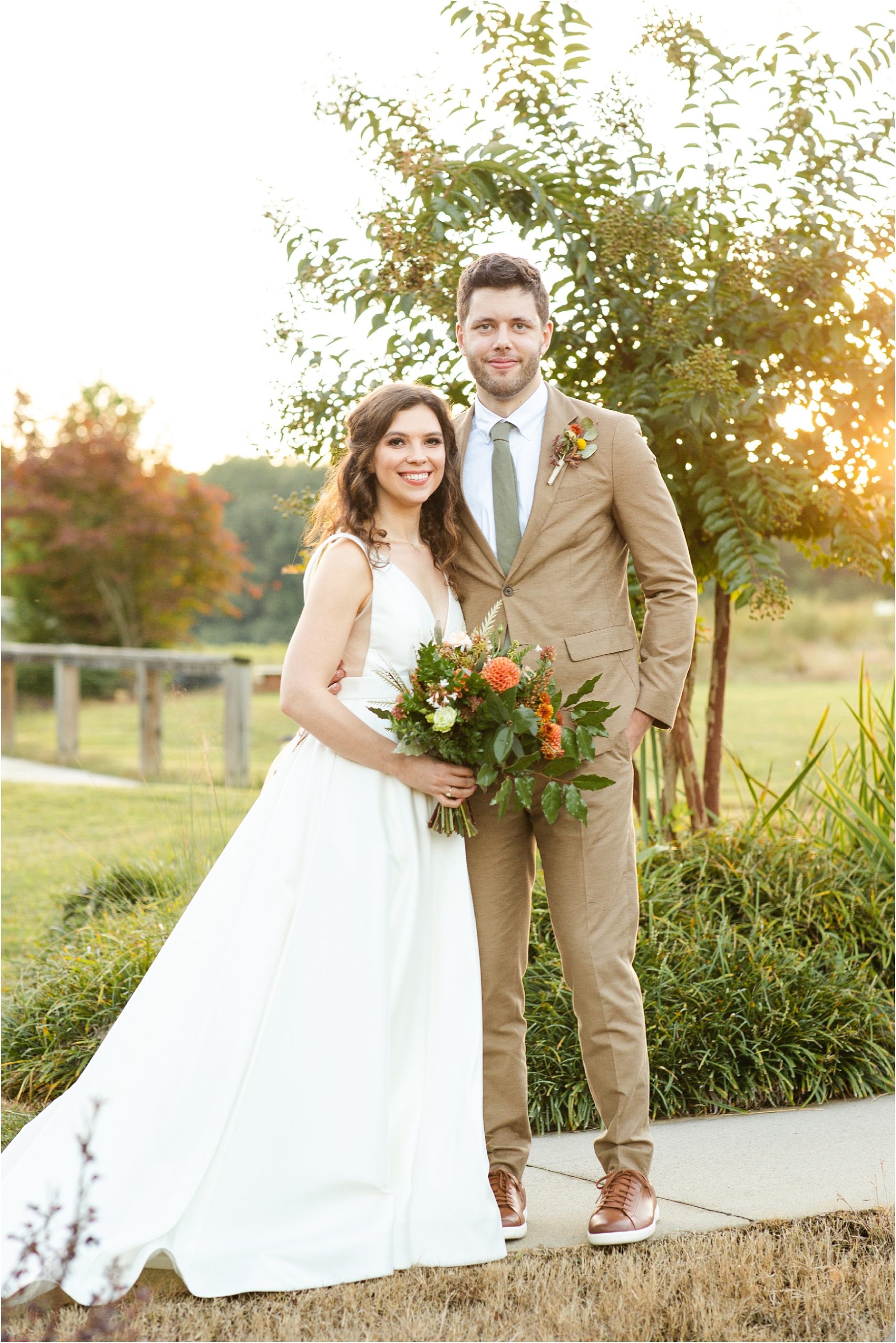 Couple stands on a farm after their wedding in Greenville, SC