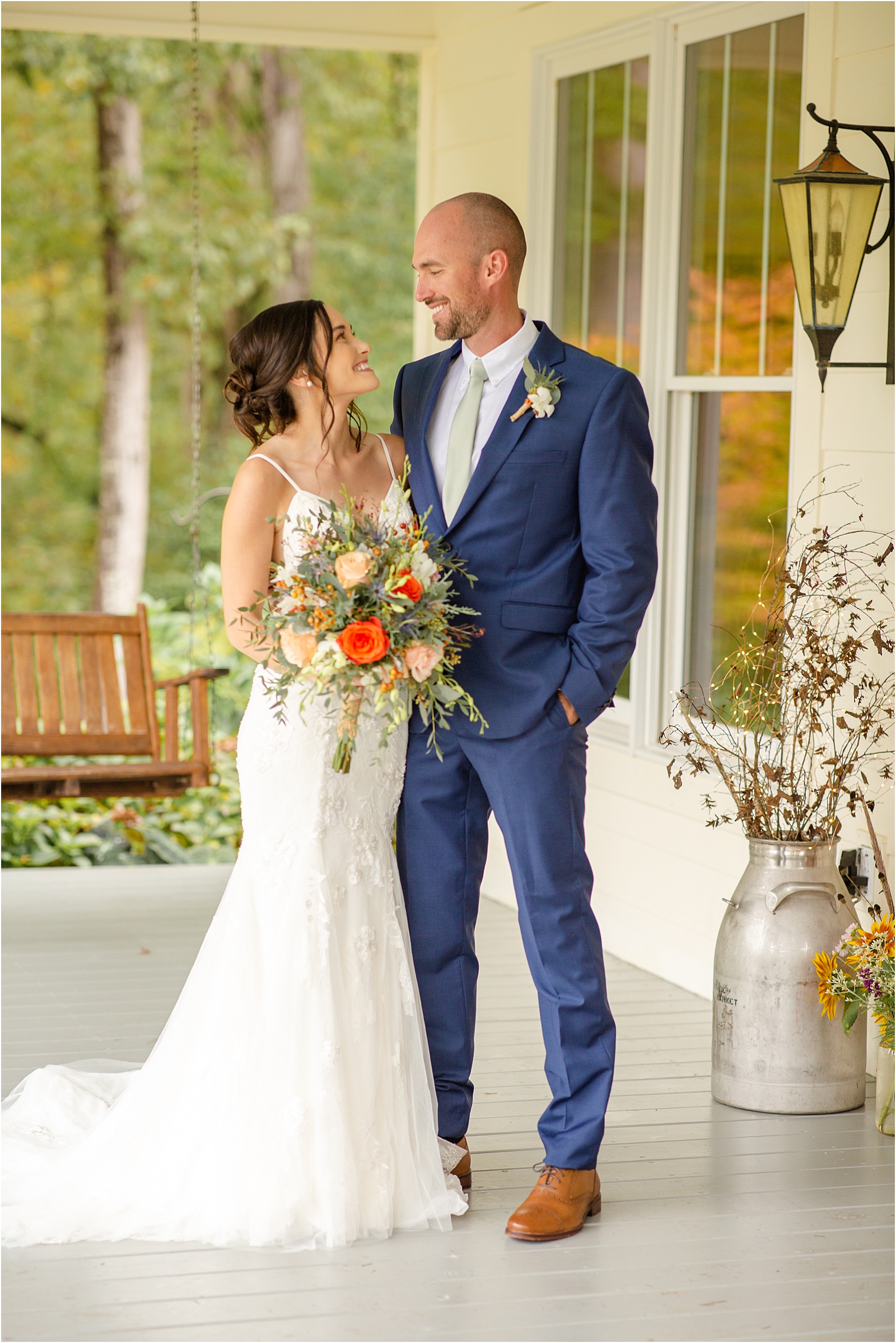 bride and groom smile at each other while they stand on a porch in Anderson, SC