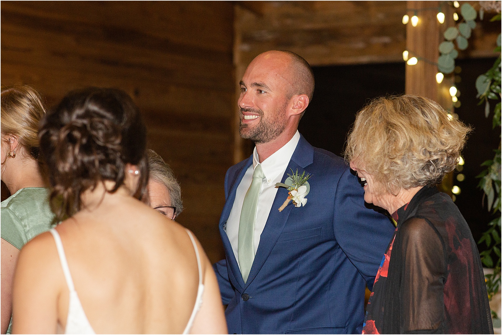 Wedding groom talks with guests at wedding reception