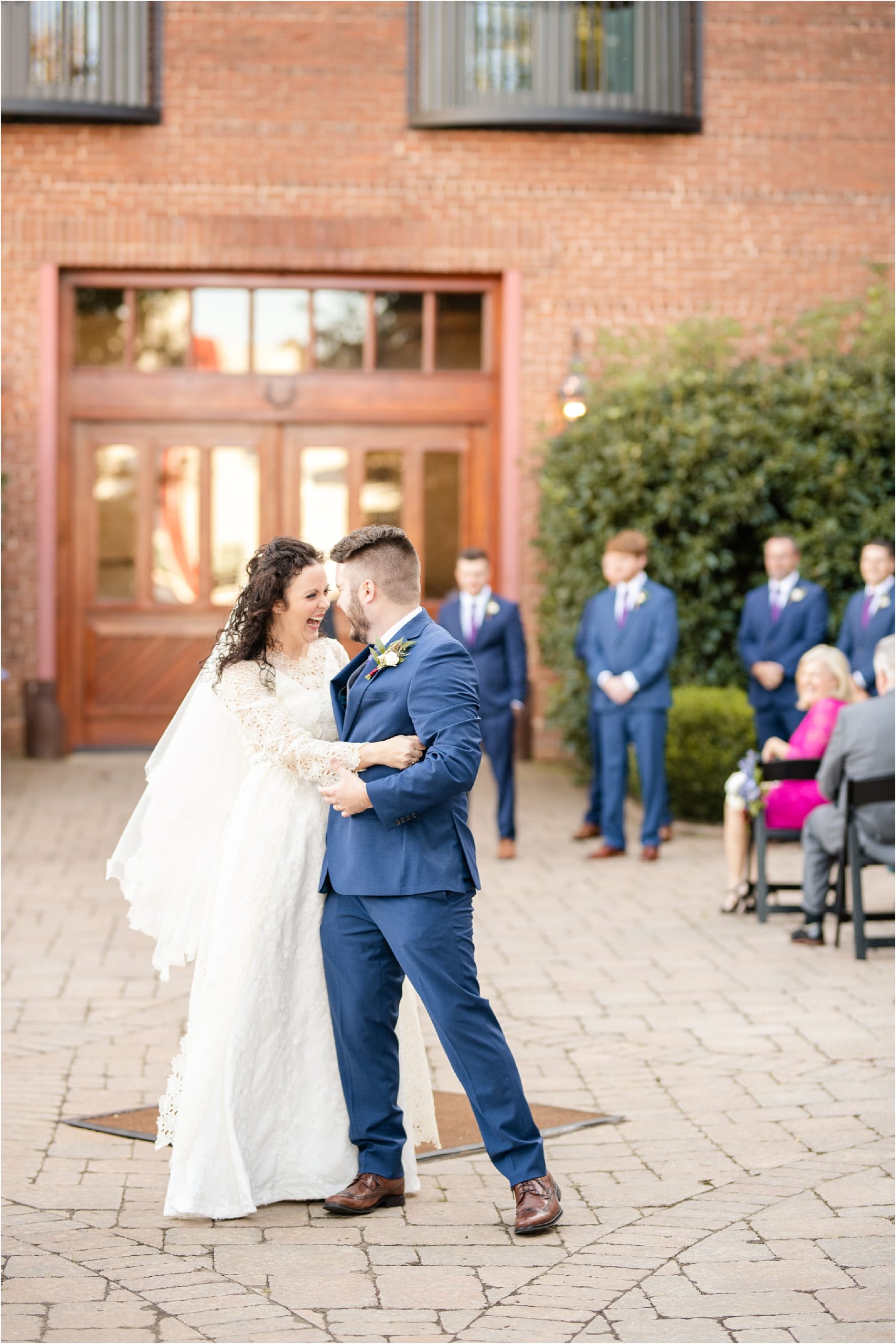 just married couple dance down the aisle of Bleckley Inn Courtyard