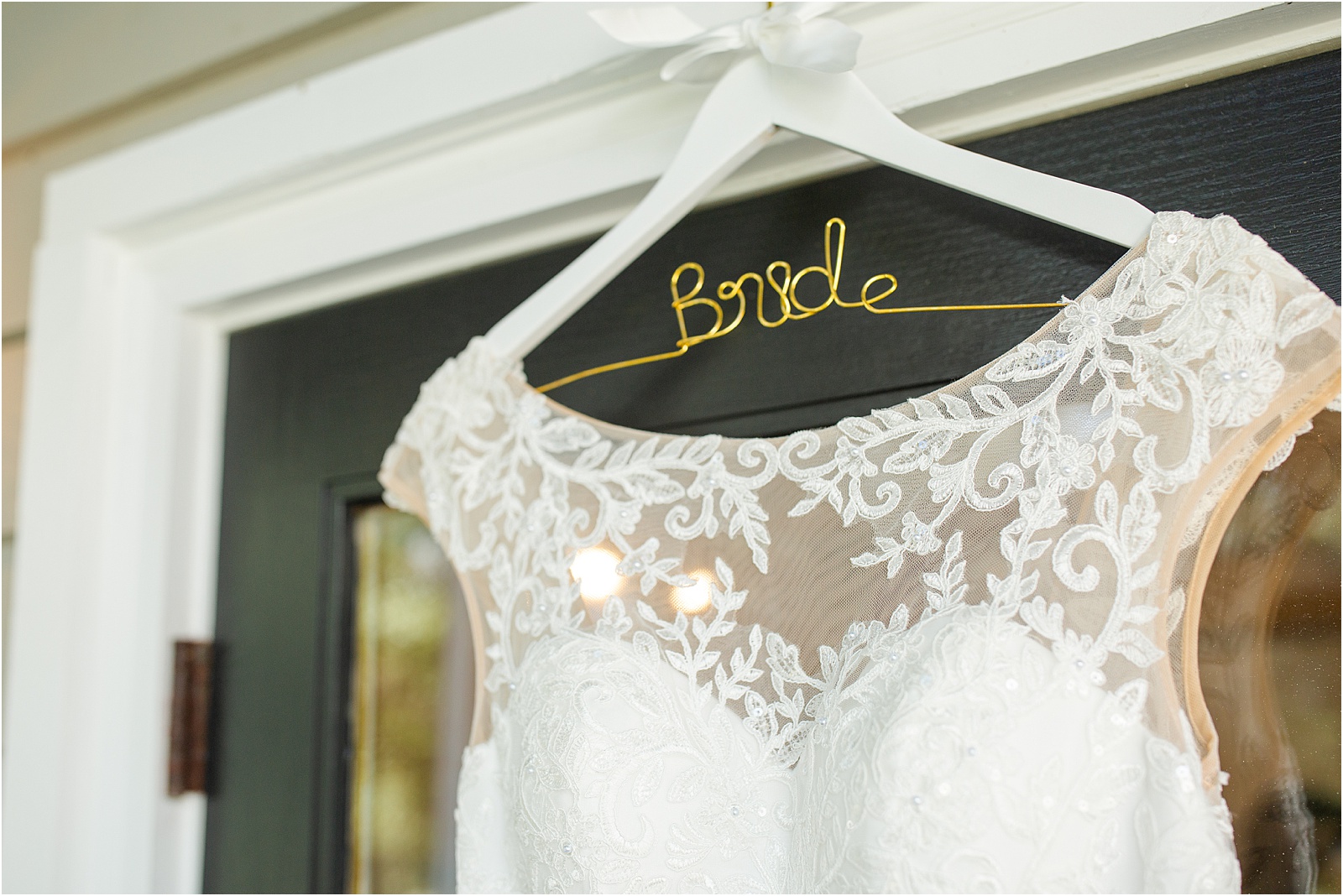 Wedding dress hanging on a hanger that says bride