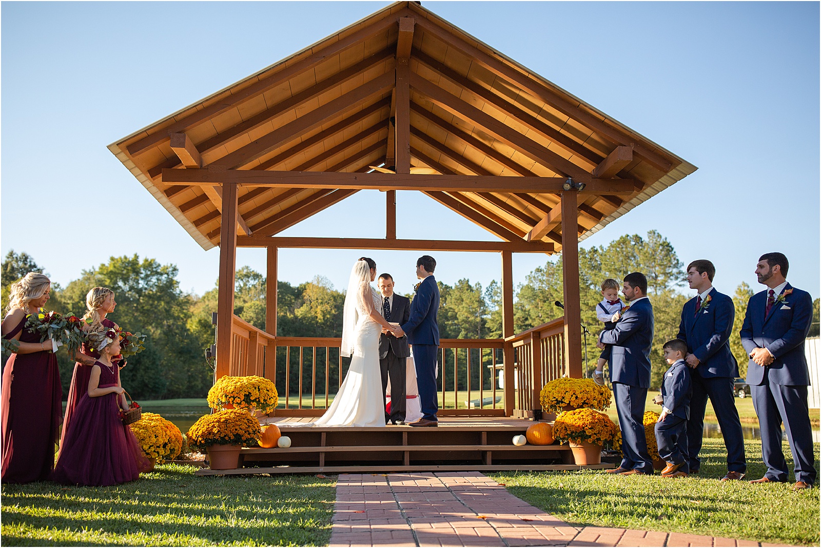 bride and groom facing each other holding hands at their outdoor wedding ceremony in Richland SC