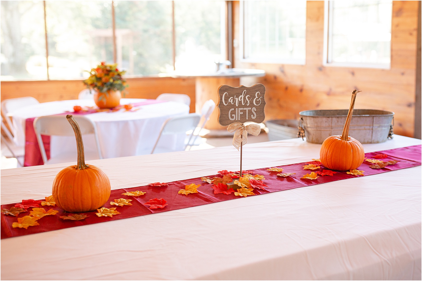 Gift table at wedding reception with leaves and pumpkins