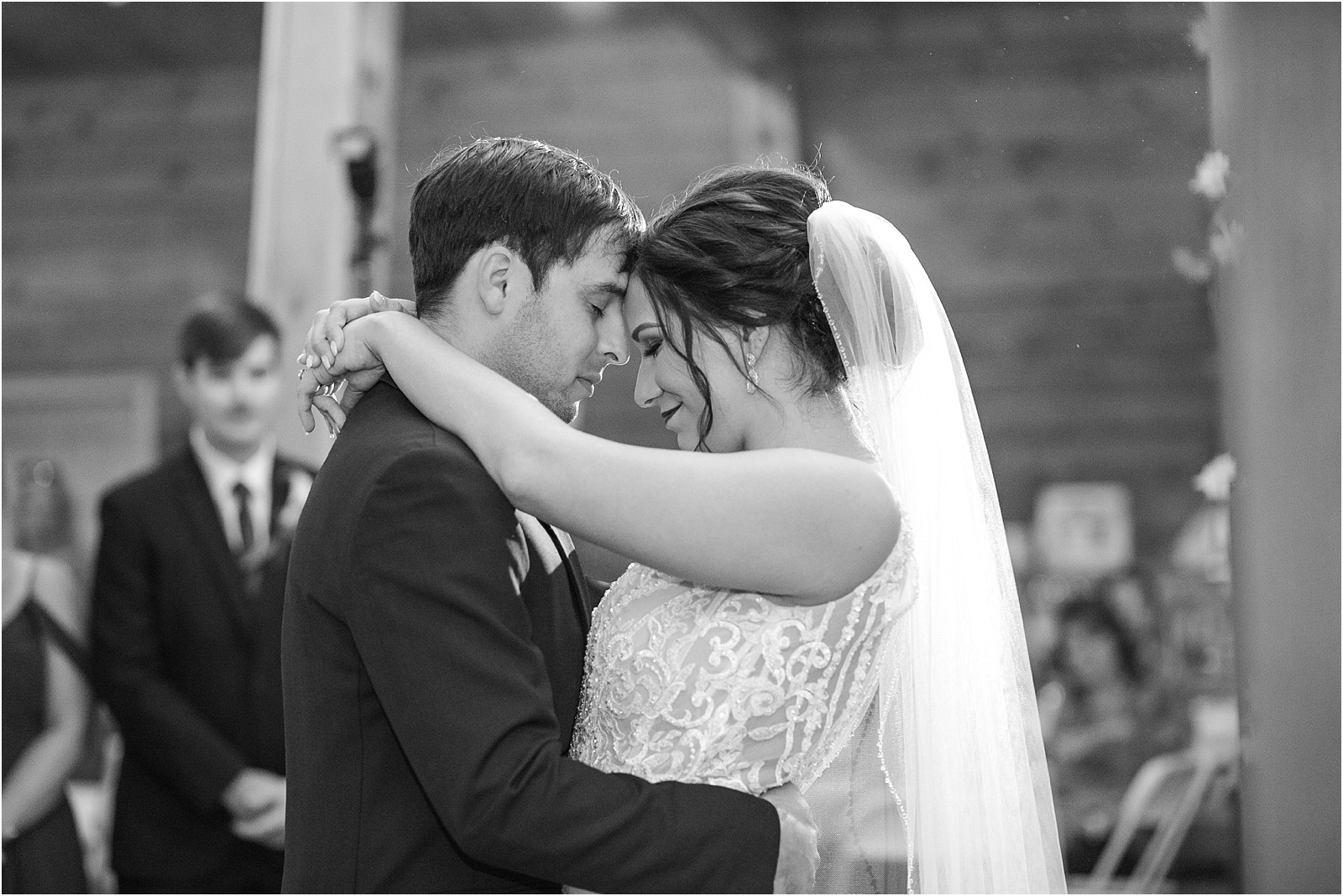 Bride and groom dance forehead to forehead during first dance after wedding