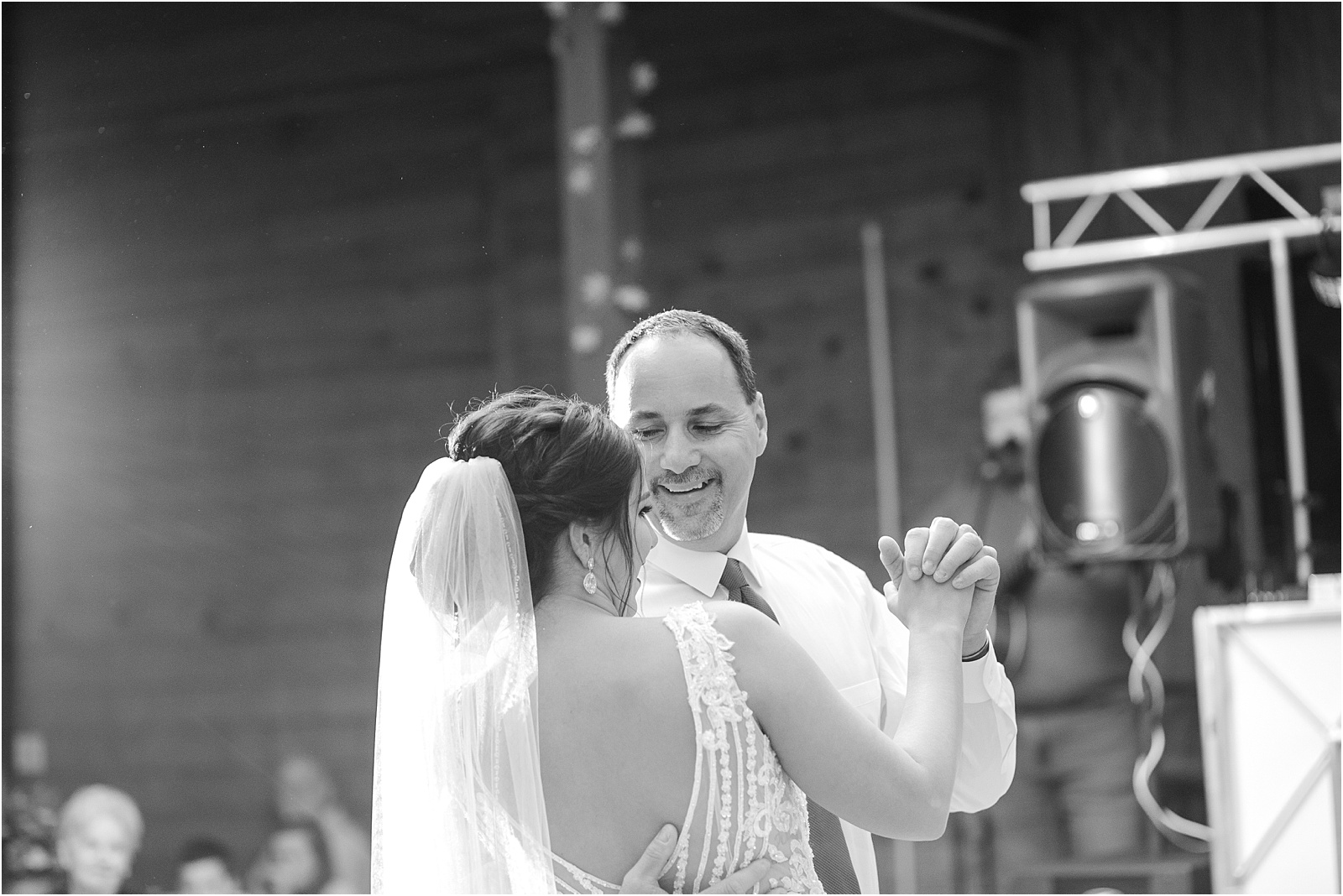 bride in modern wedding dress dances with her dad