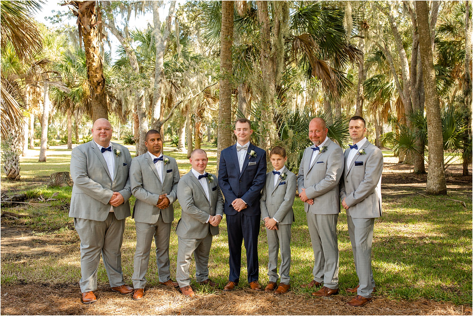 groomsmen in gray jackets with groom in dark blue jacket