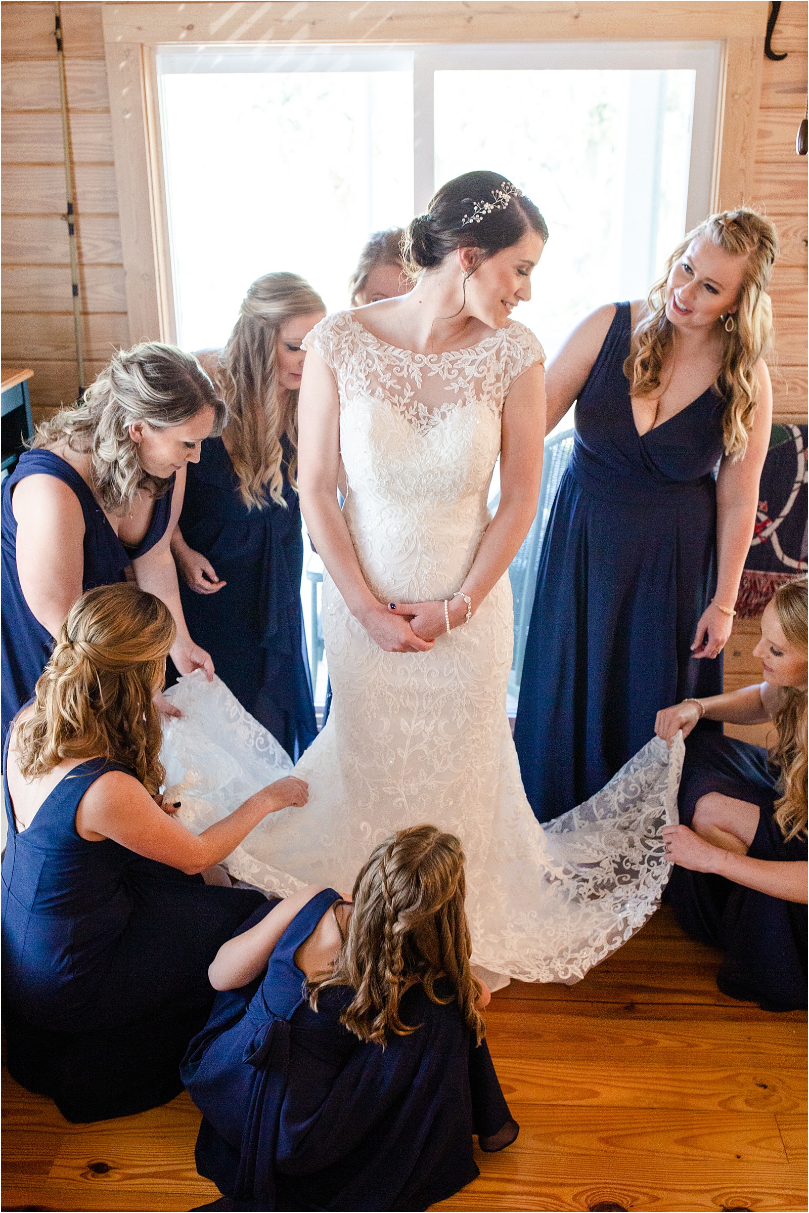 bridesmaids help fix wedding dress