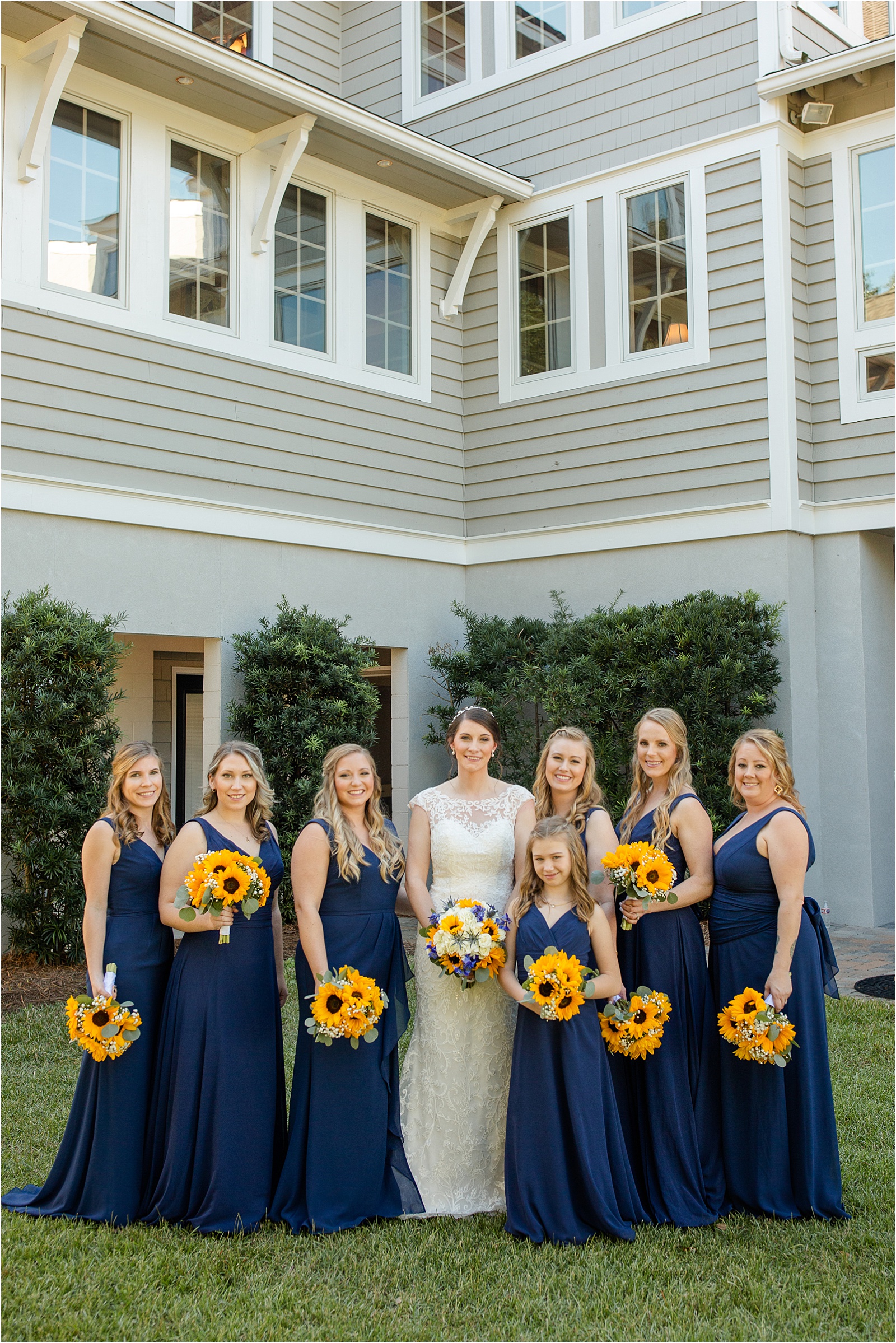 Edisto wedding bridal group holding sunflower bouquets
