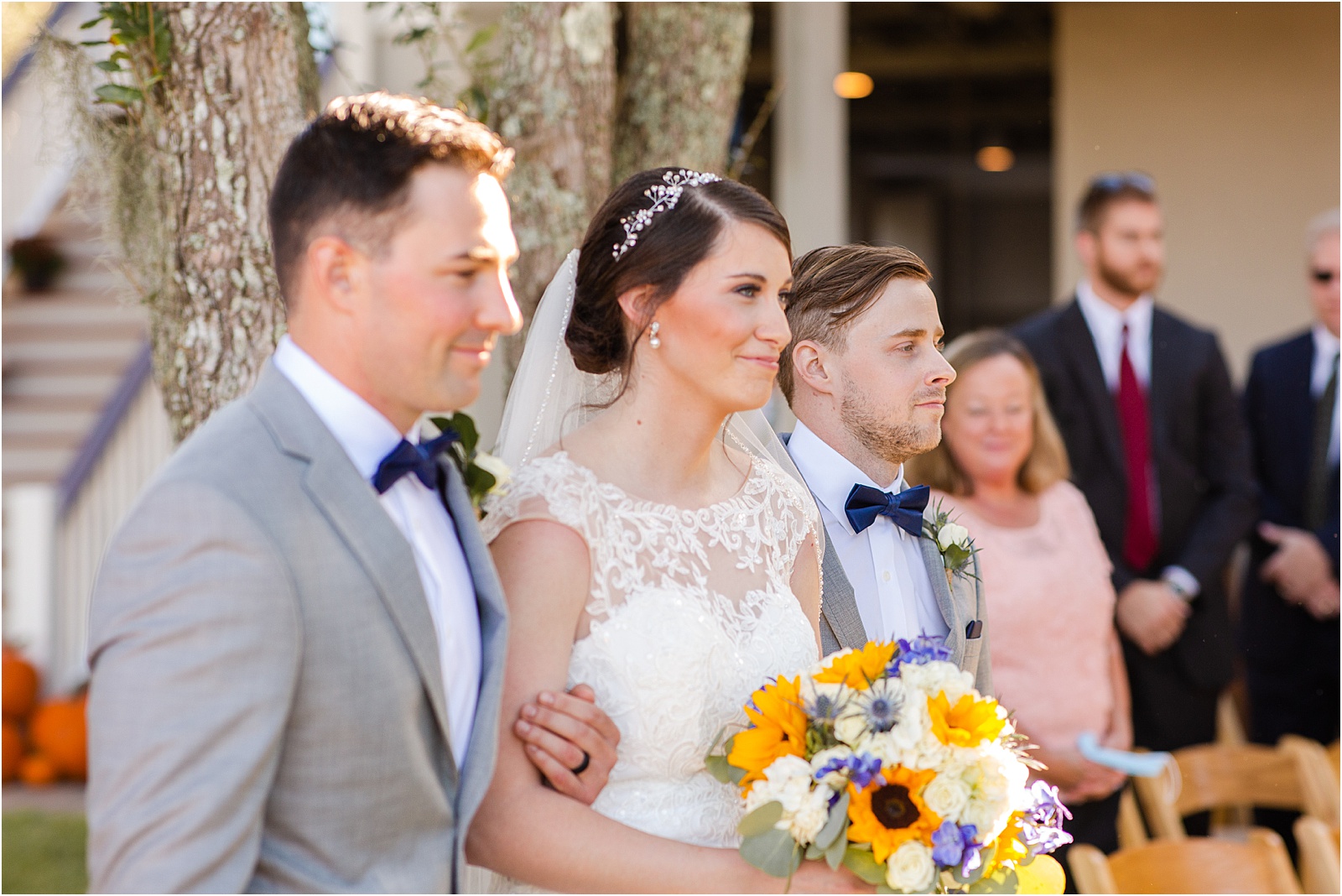 Bride walks with brothers down the aisle