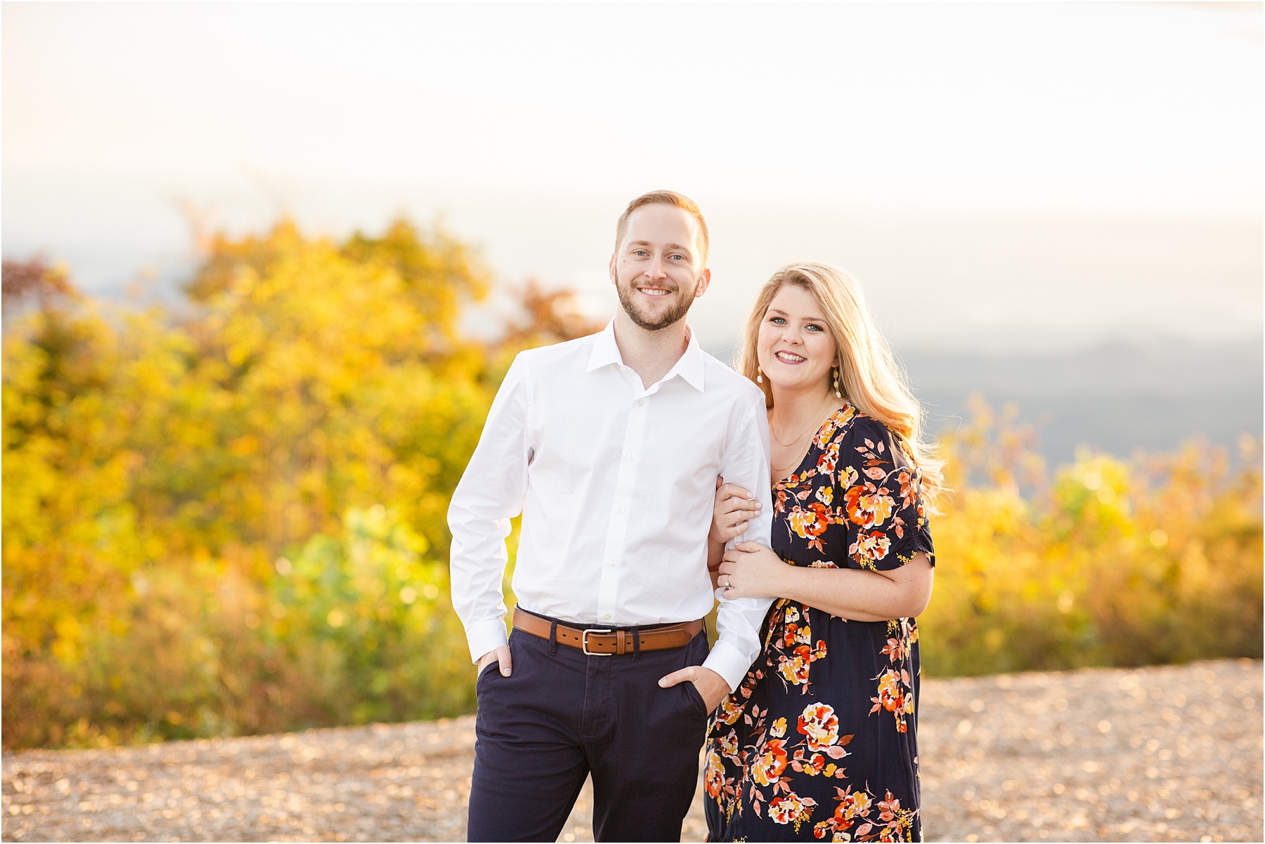 Man and woman standing on top of Greenville mountain for engagement session