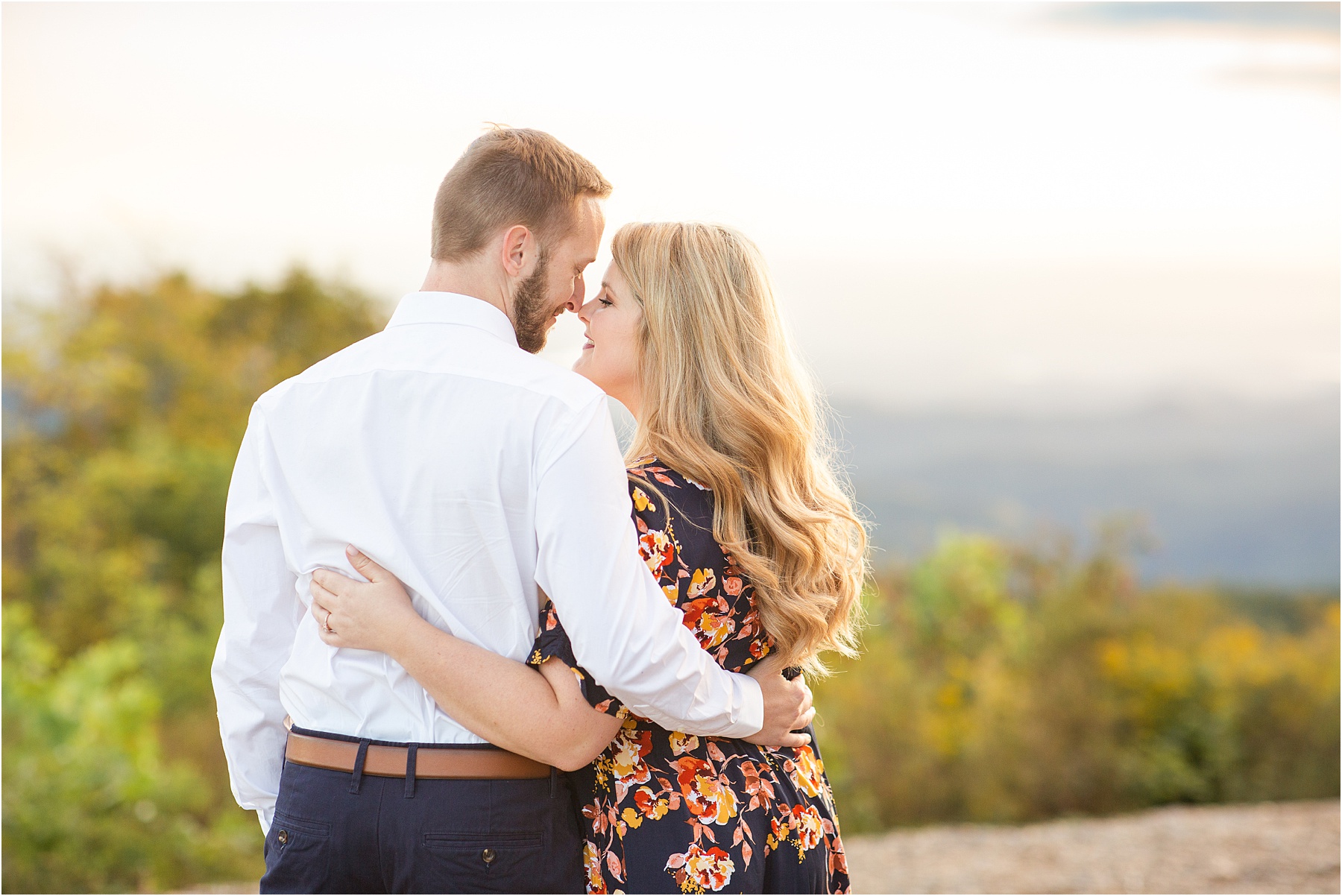 Engaged couple touches noses on mountain in Pickens SC