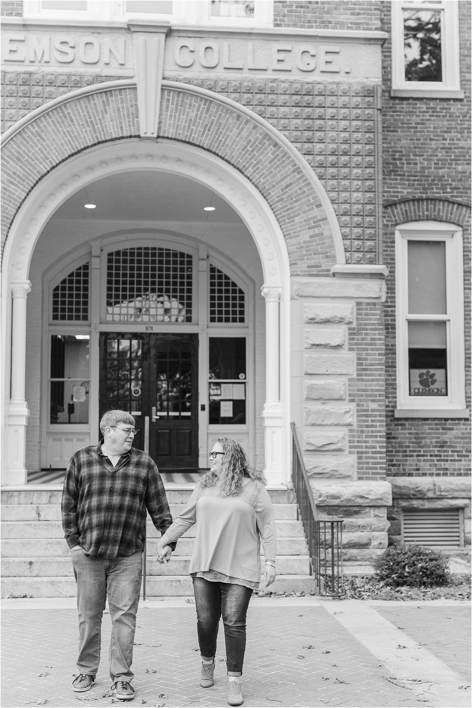 couple walking towards camera in front of Tillman Hall