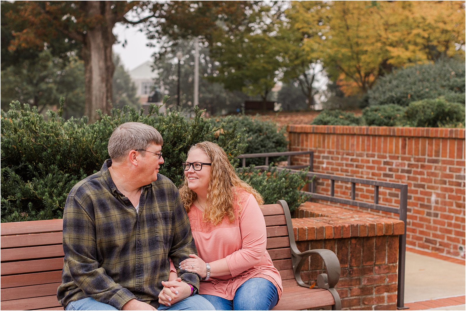 man and woman sitting on a park bench on Clemson university campus