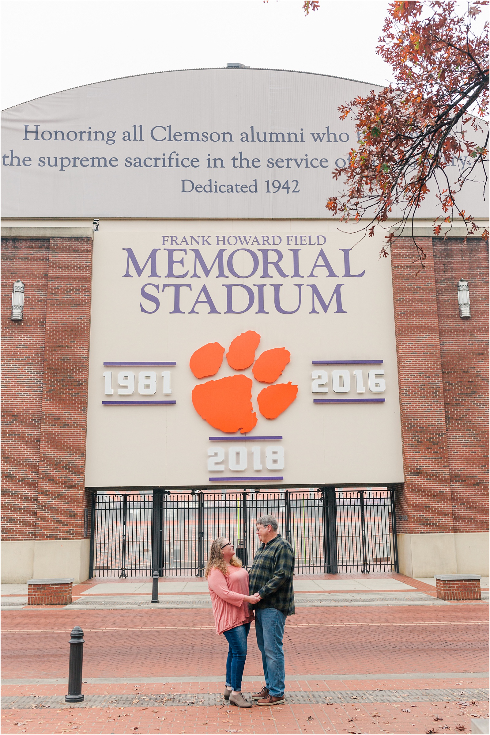 engaged couple standing in front of Clemson Football Stadium