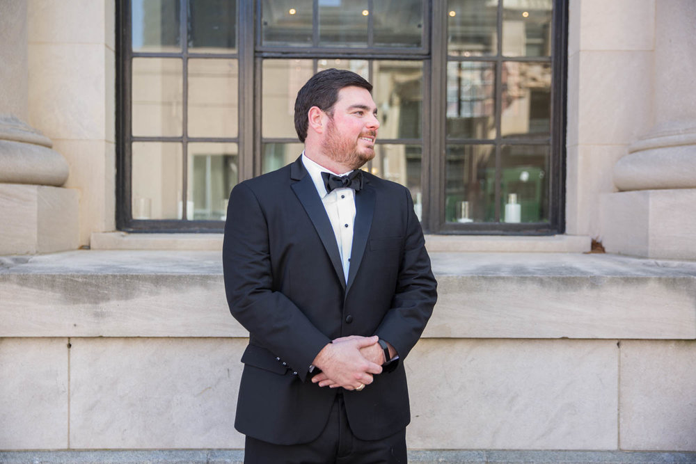 Groom waiting on his bride as he standing in downtown Columbia