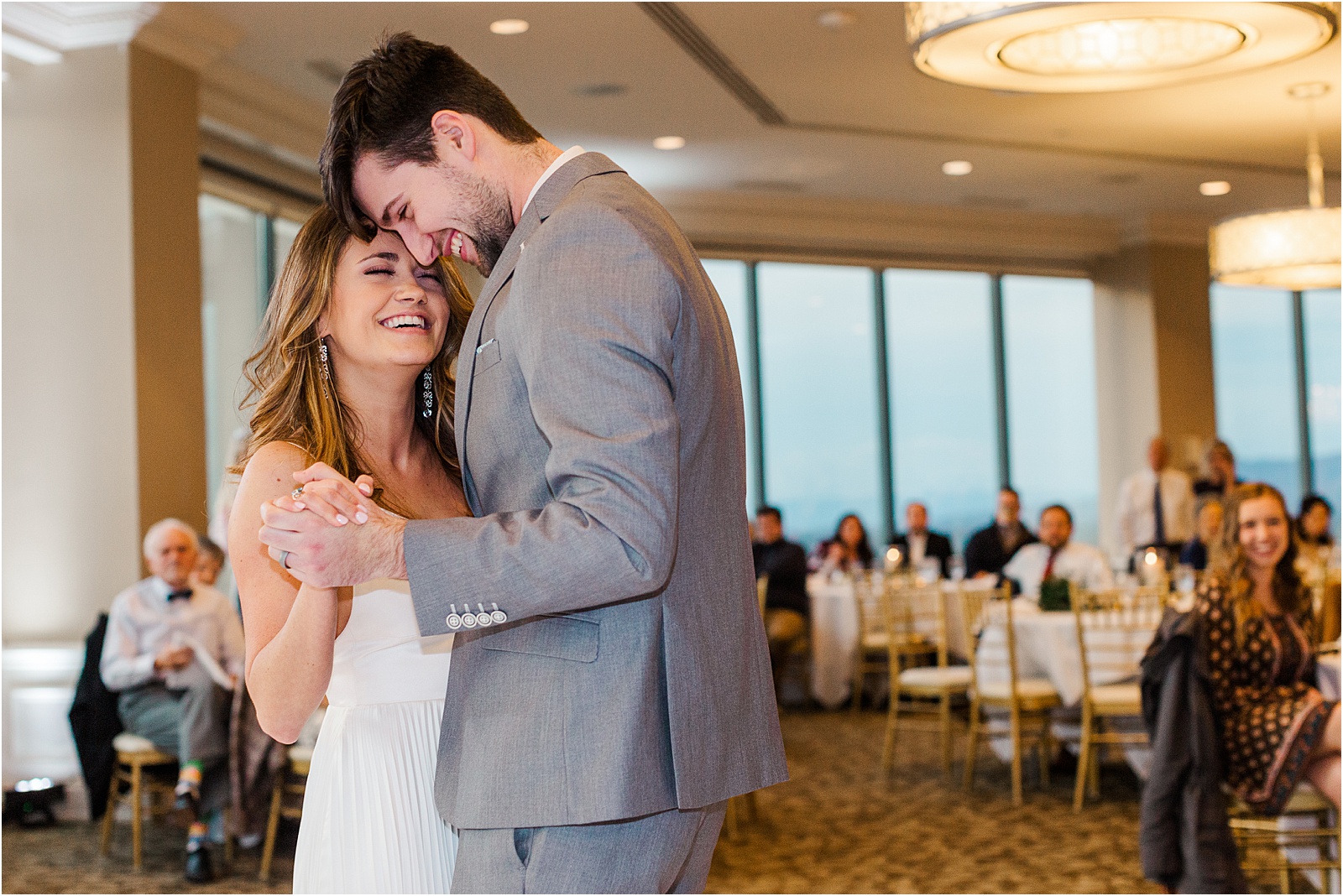 newlyweds smile at each other during first dance