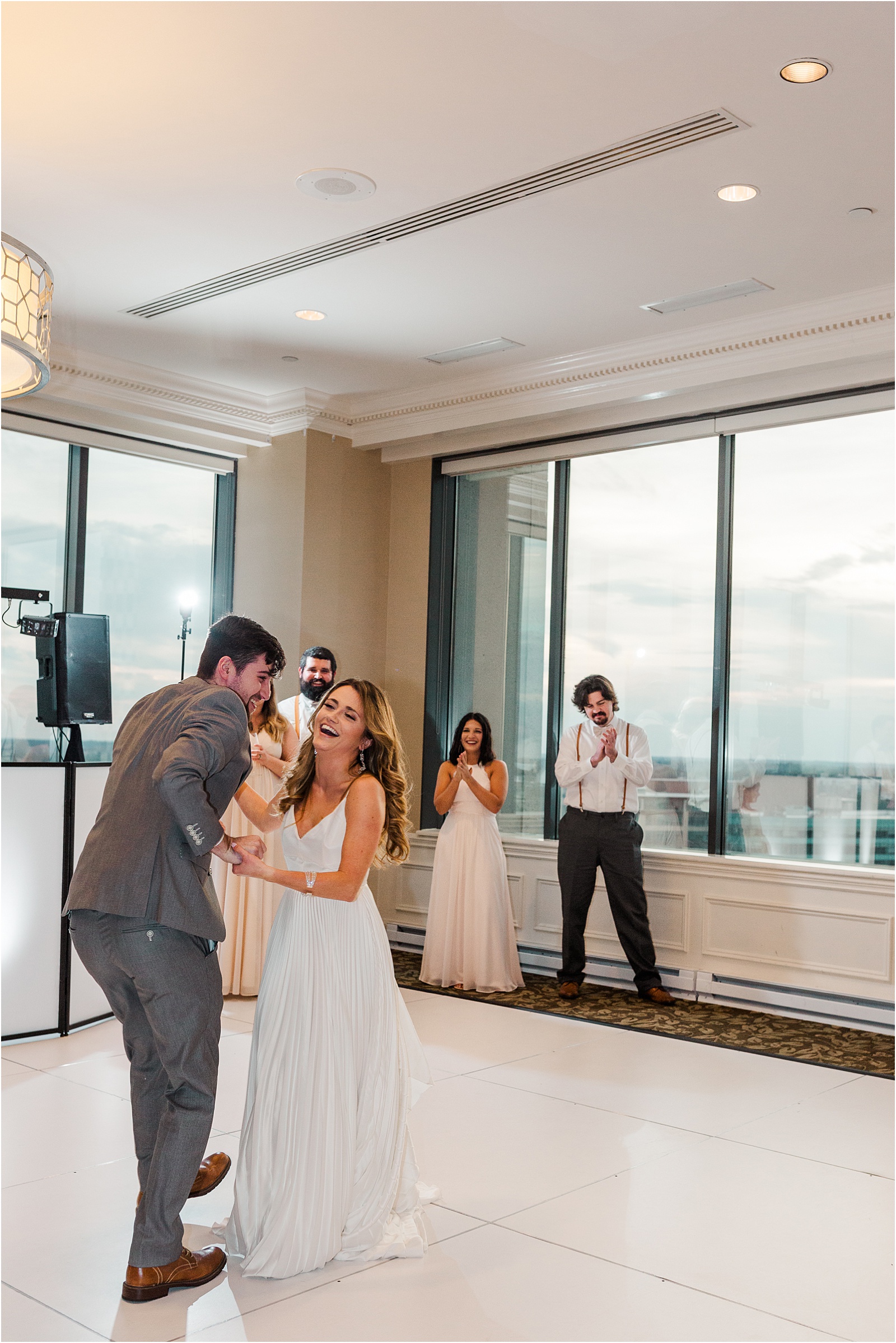 bride laughs during first dance with husband