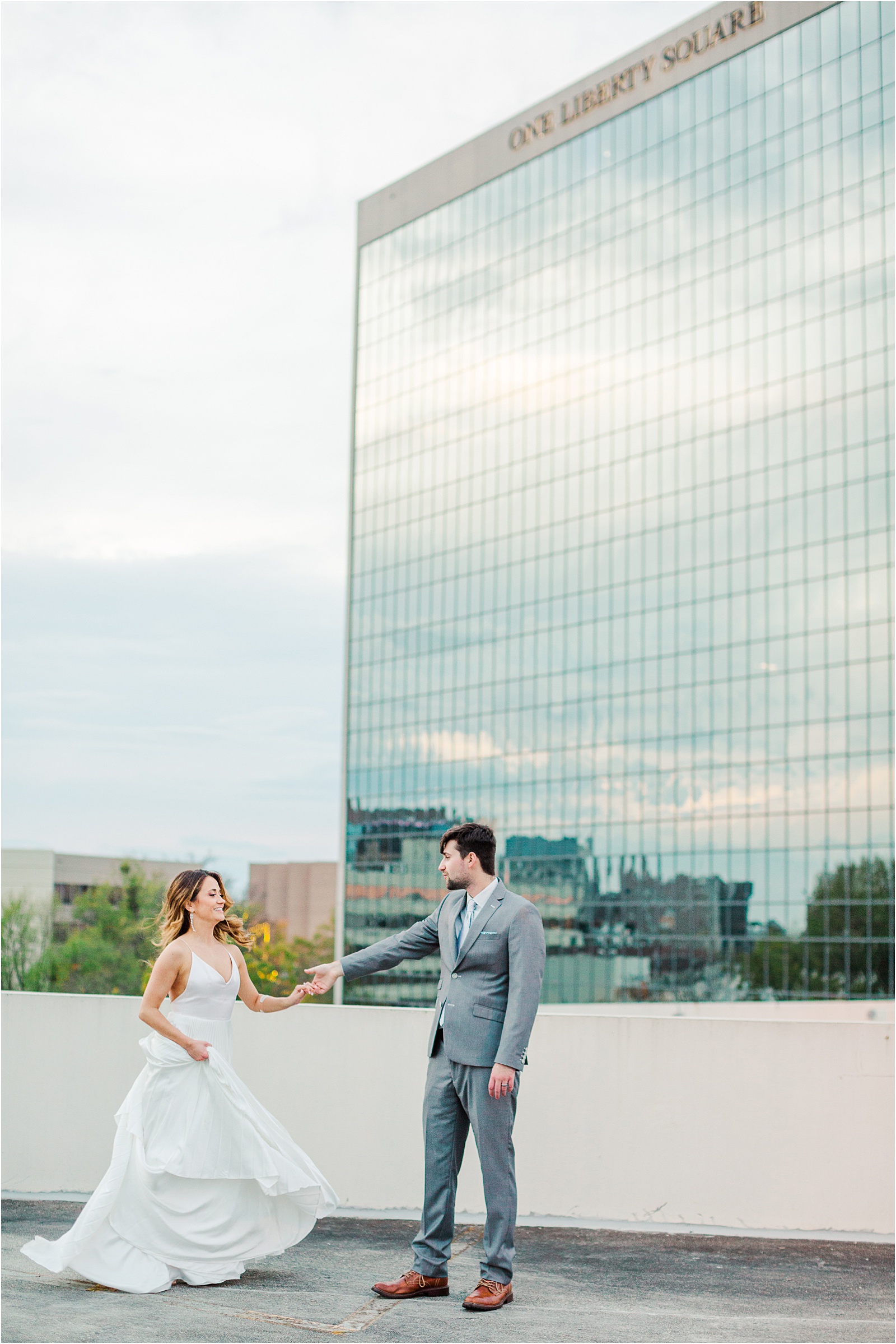 newlyweds dancing at the top of parking garage in Greenville
