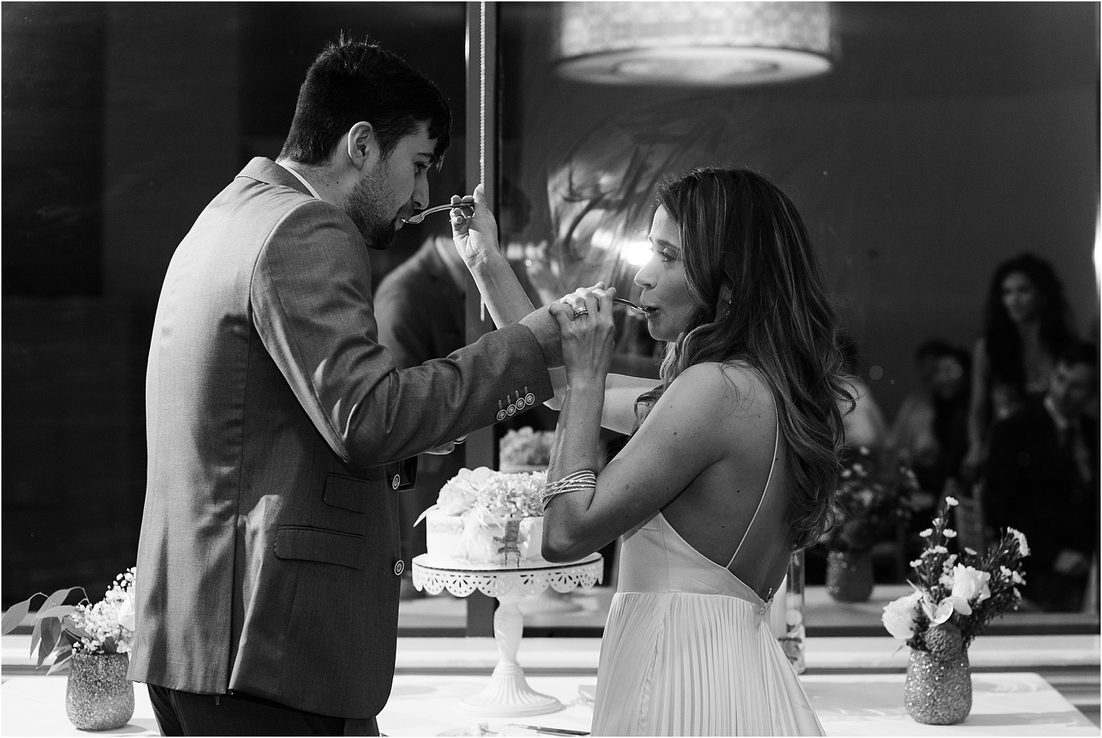 just married couple feeding each other cake on forks