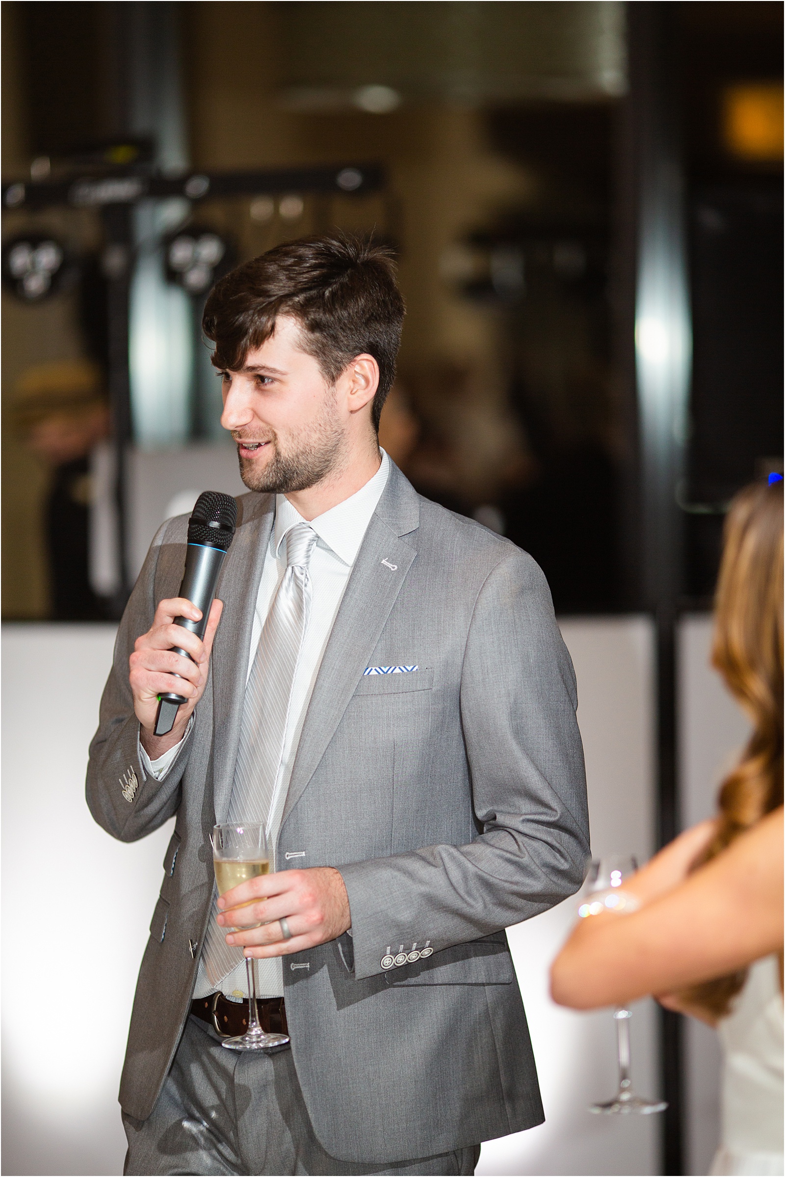 groom gives speech at wedding reception holding mic