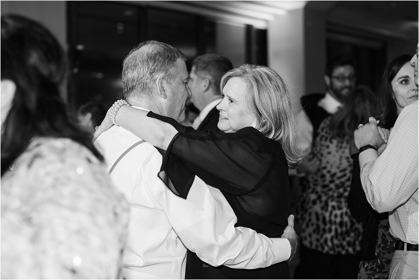 father of brie dancing with wife in black and white