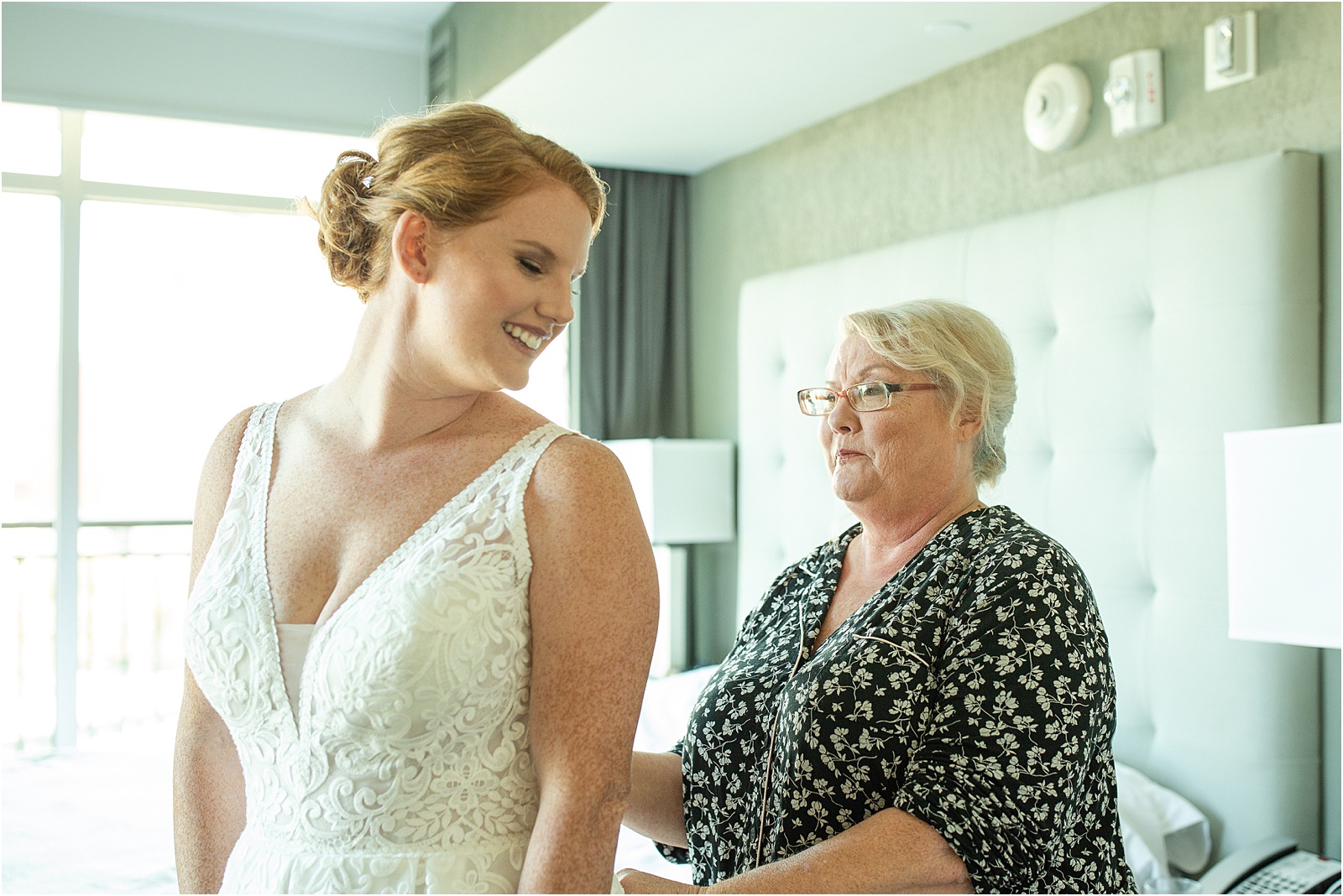 mother of the bride zipping up wedding dress