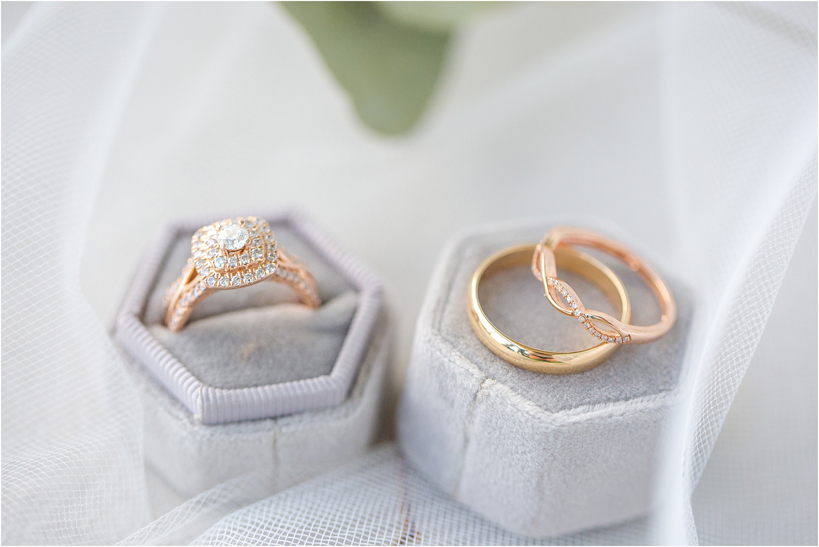 man and woman's wedding rings on grey ring boxes