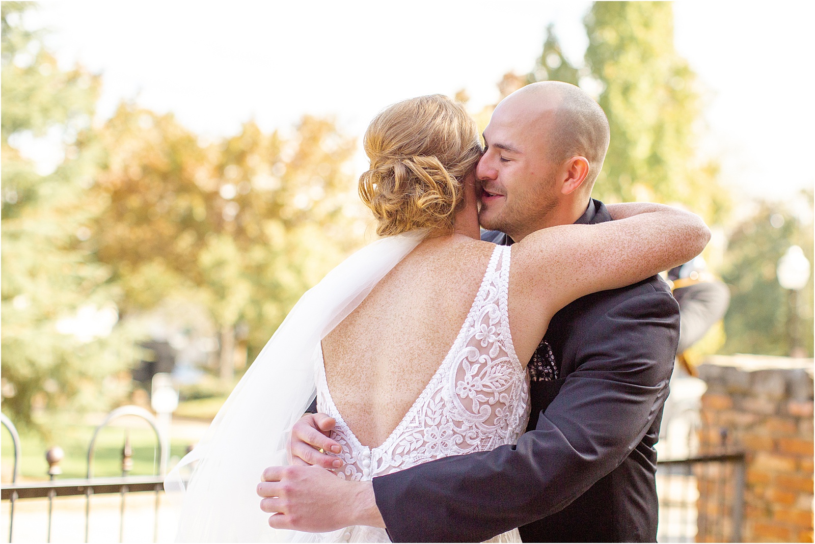 groom whispers in bride's ear during first look
