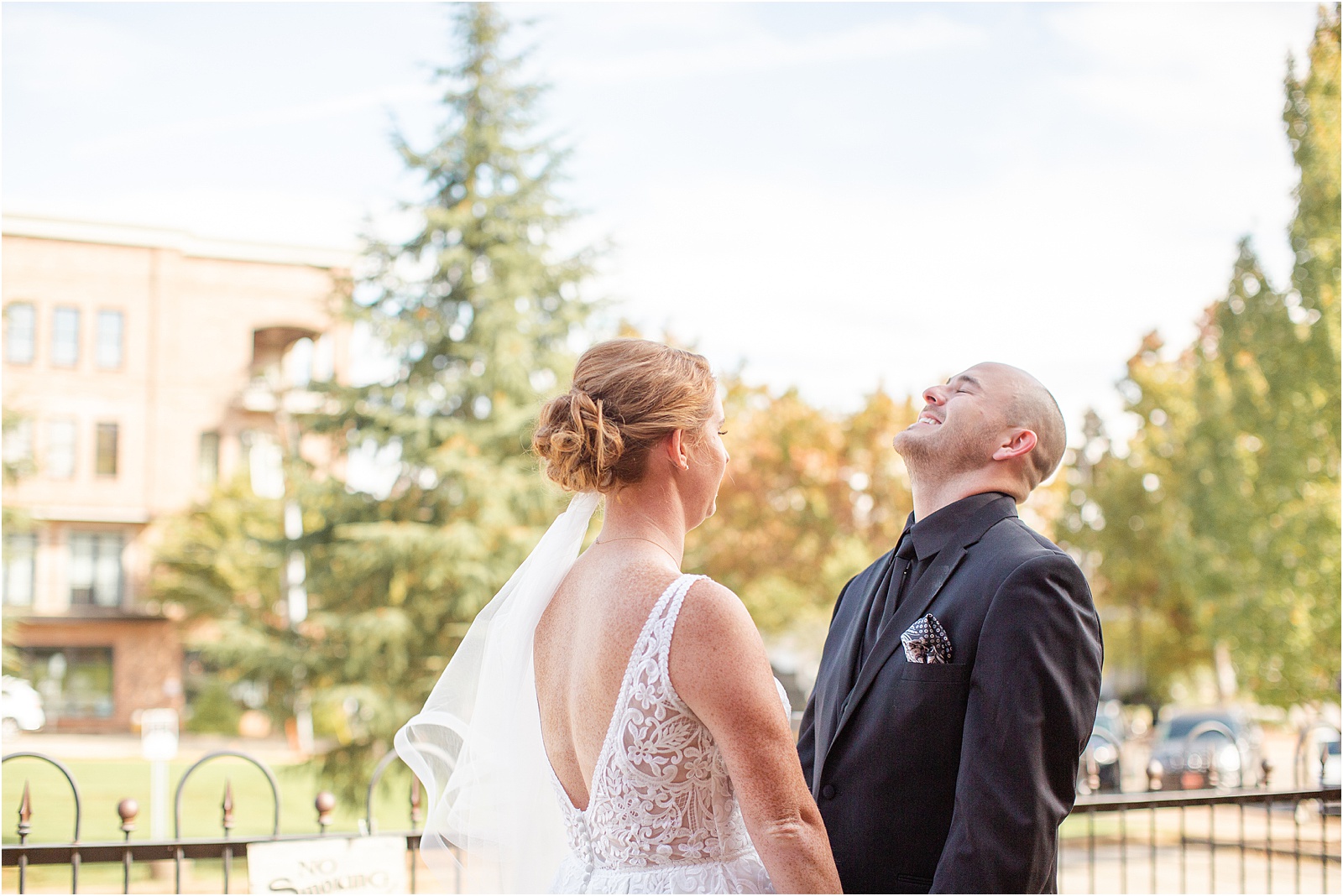 groom laughs with bride during their first look before wedding ceremony