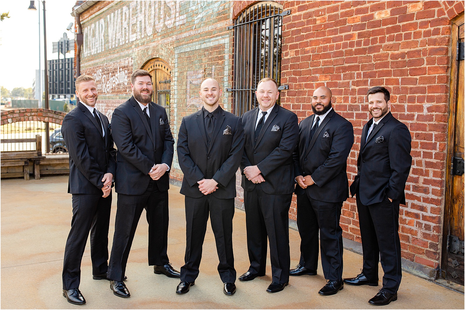 Groom and friends lined up outside warehouse venue in Greenville, SC