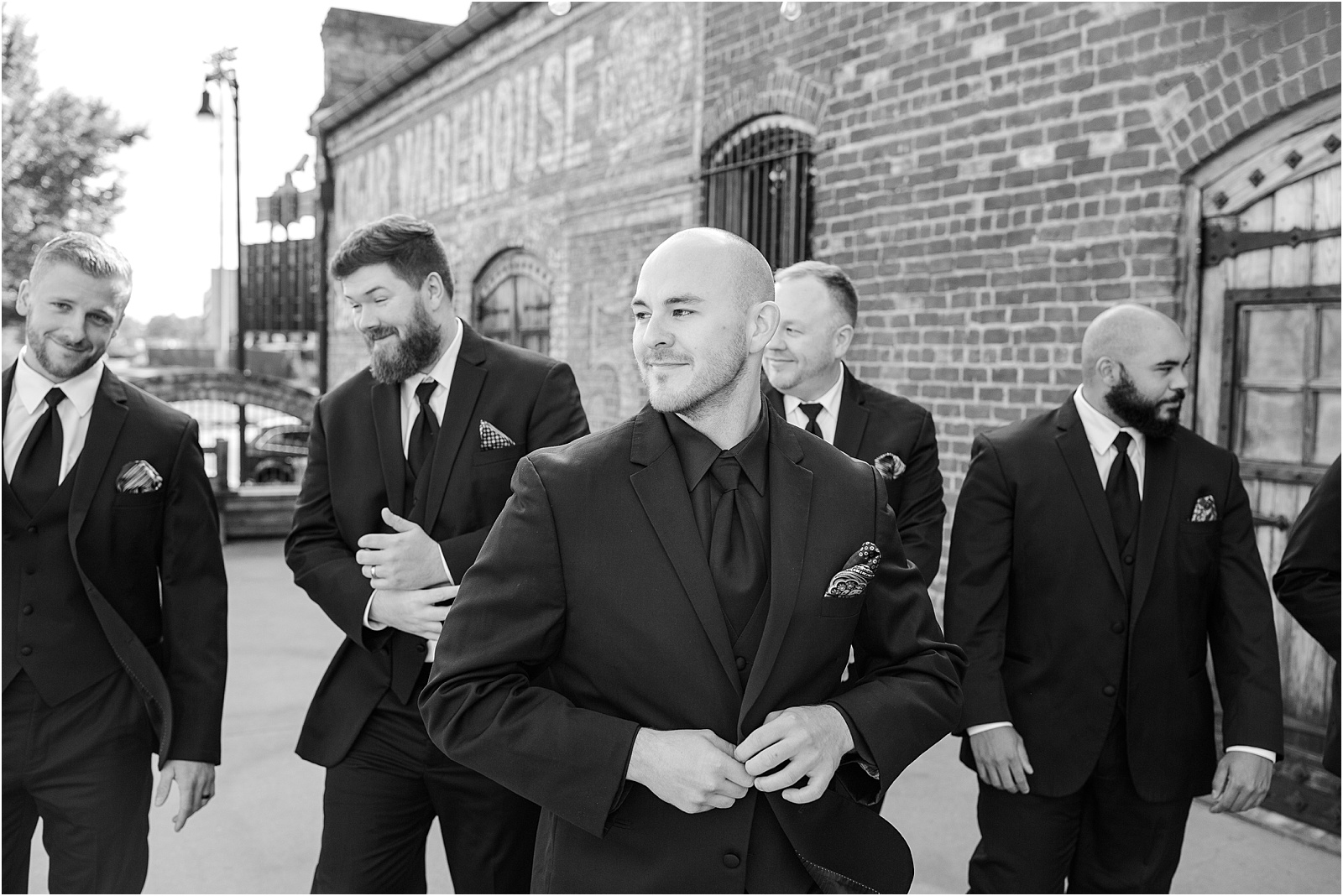 black and white photo of groom with groomsmen before wedding ceremony